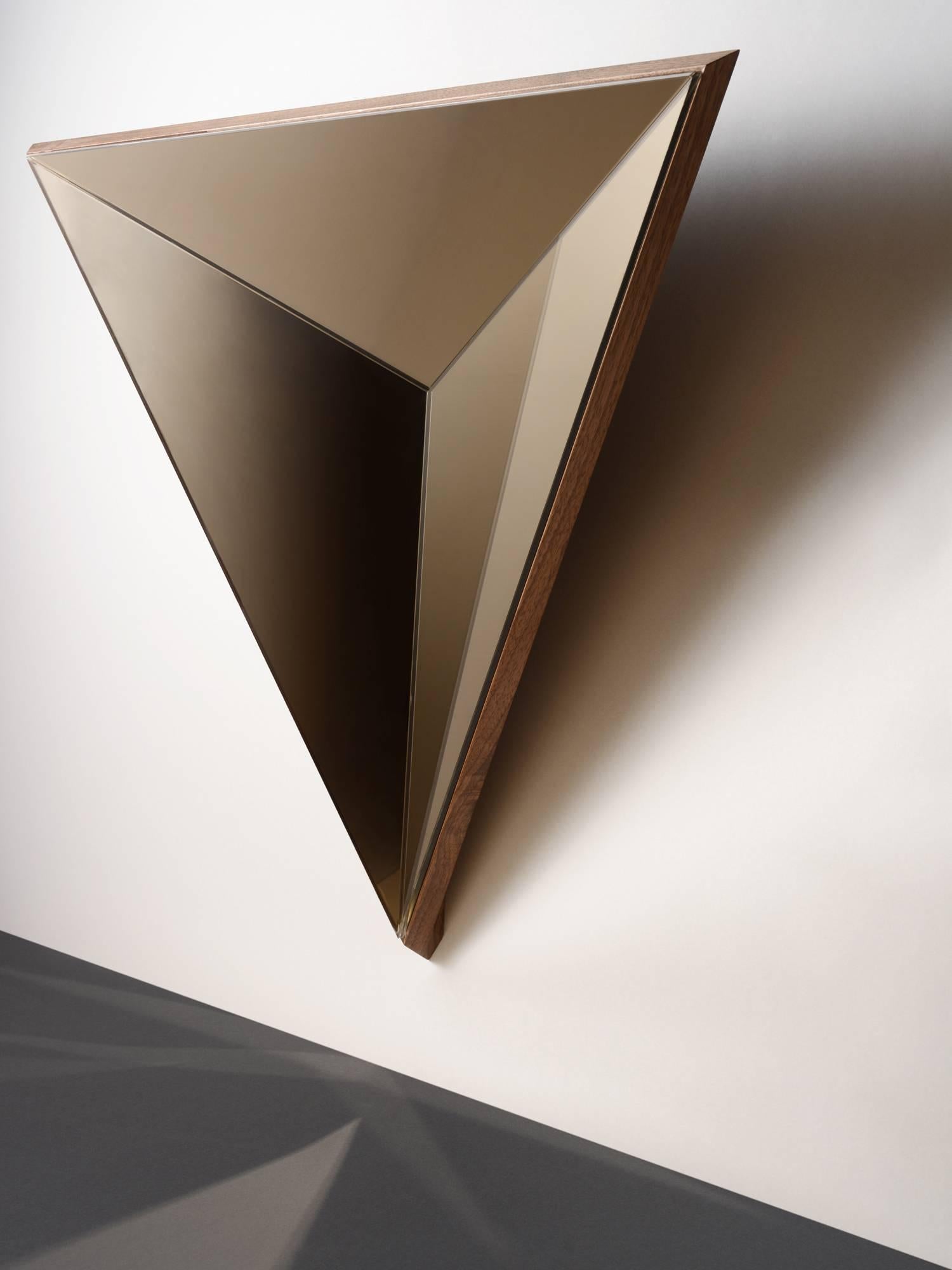 The volume mirror continues Robert Sukrachand fascination with three-dimensional, reflective surfaces. Eschewing the convention that a mirrors' primary function is for viewing ones own reflection, these graphic pieces offer the warm, atmospheric