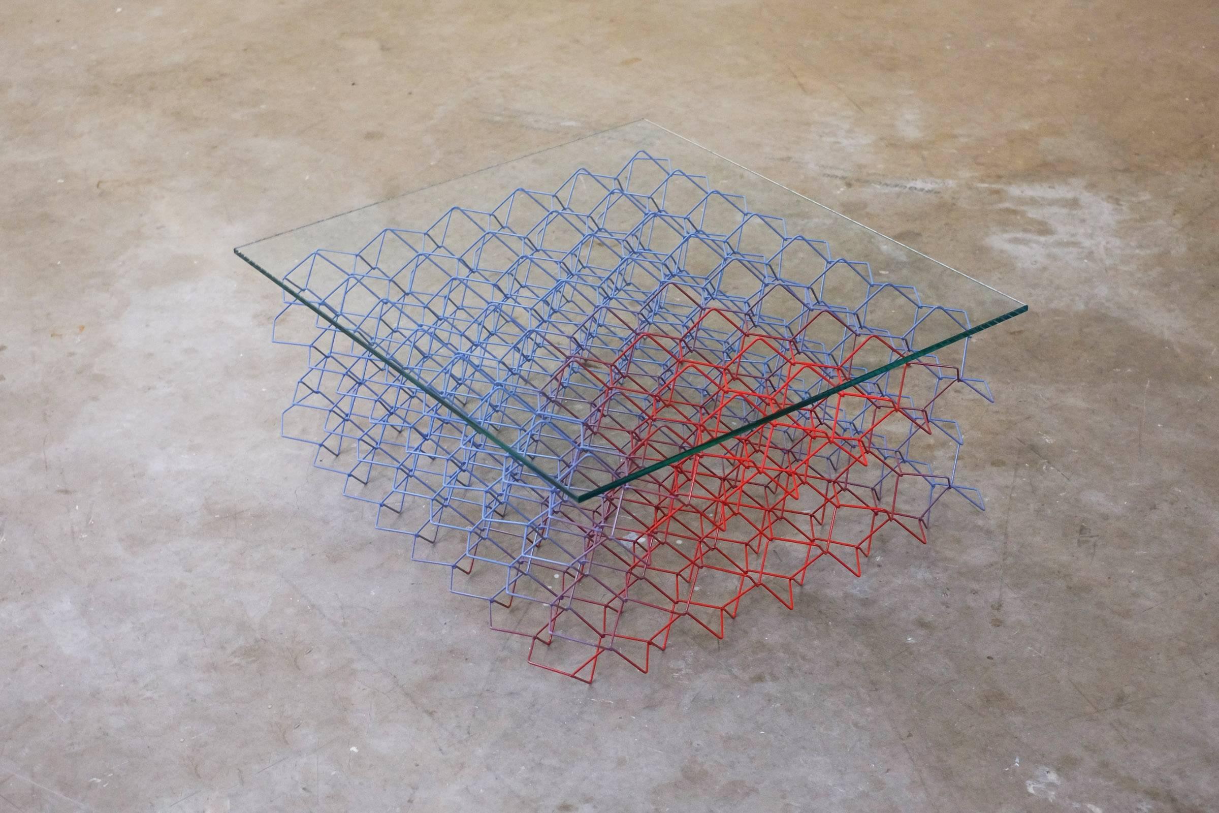 The seismic coffee table was inspired by the movement and vibrations that occur in an earthquake. Three-dimensional bent and woven metal wires create a strong and dynamic structure. A range of rhythmic and geometric patterns can be discovered, when