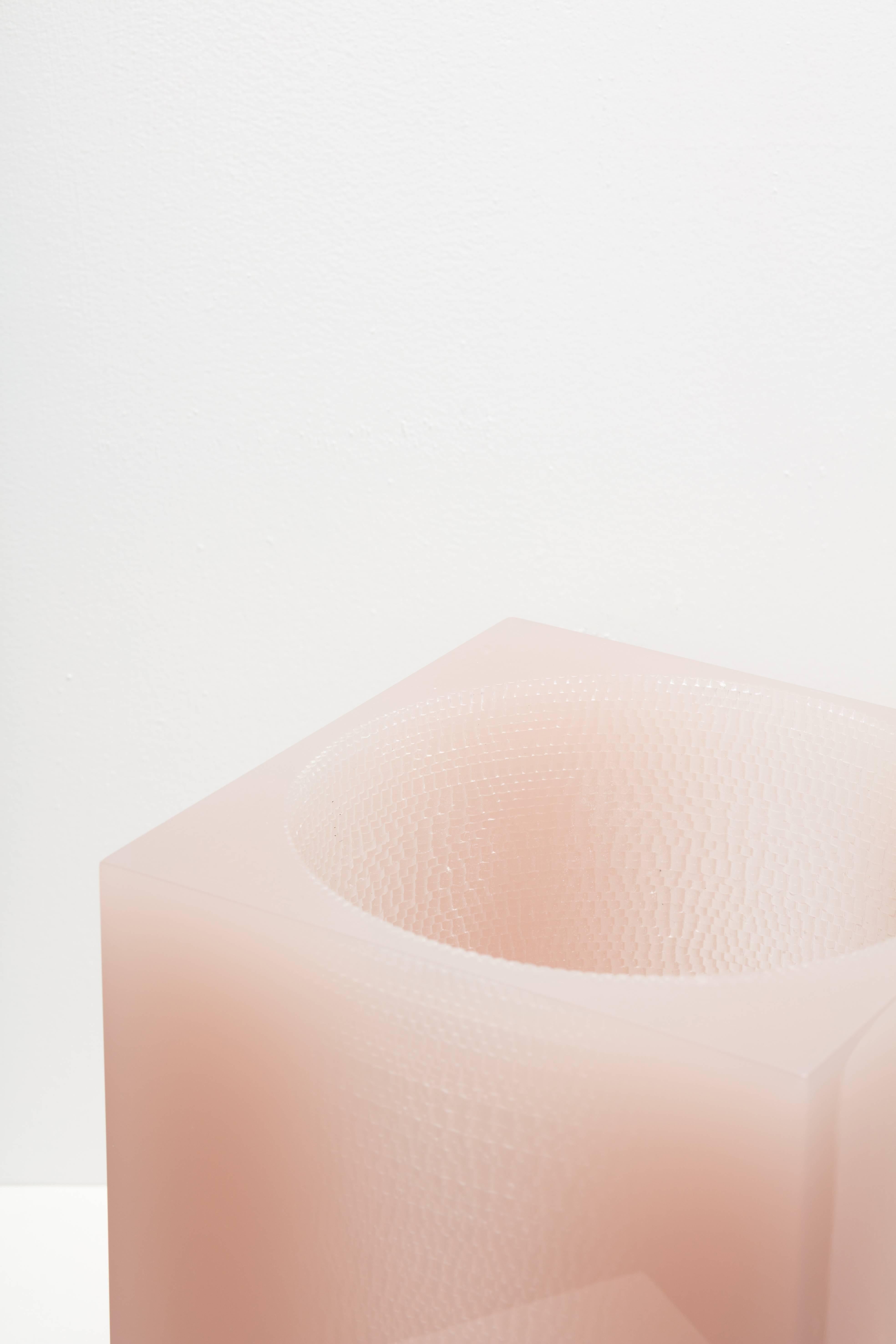 A further exploration into the designers' fascination with natural surface texture, this time in the form of a sculptural vessel of synthetic resin. A glossy square exterior exaggerates the contrast of the rich, natural texture of the circular