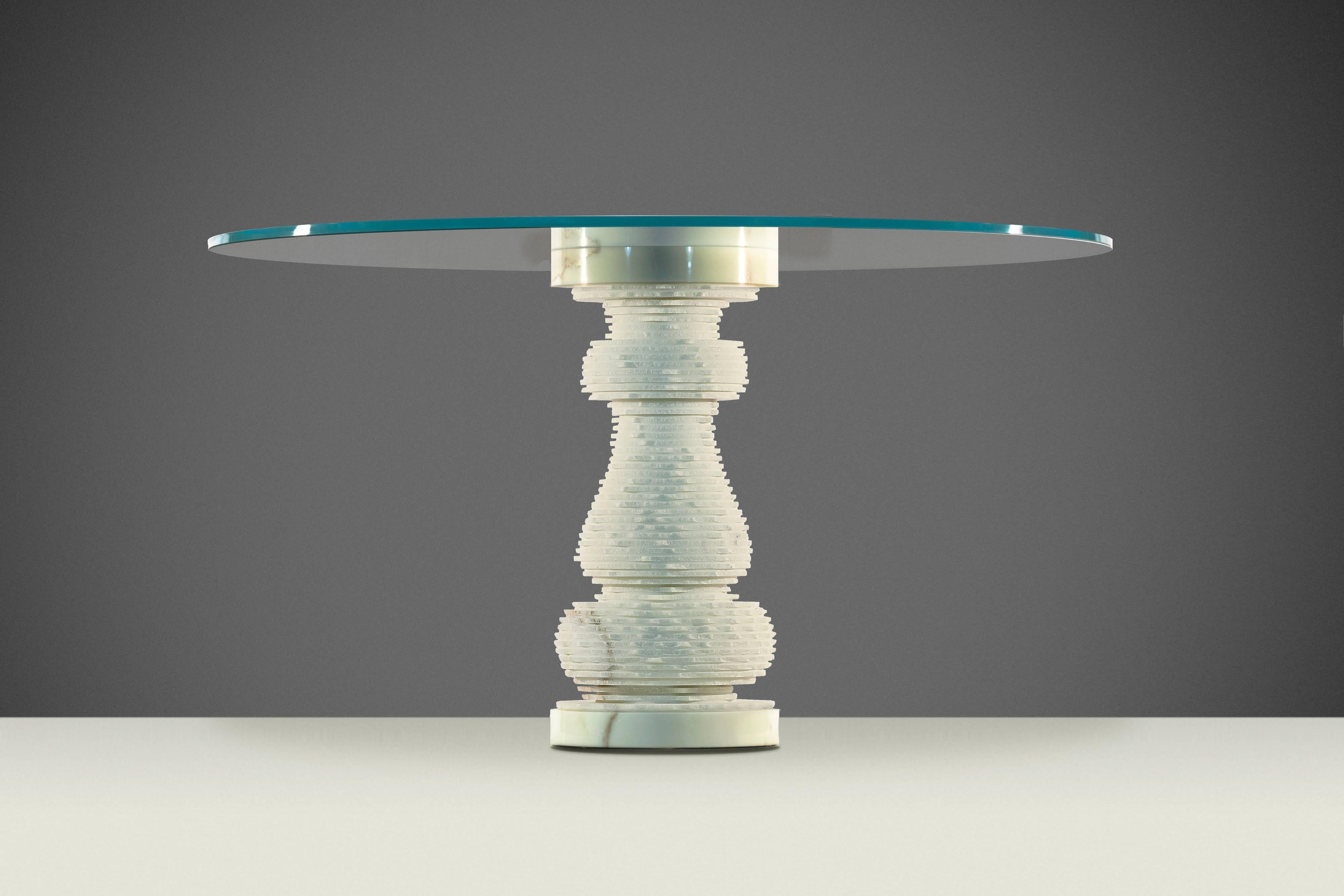 Dining table made by Paolo Ulian and Moreno Ratti. “Introverso” is a table with double soul: you can decide to keep the original cylindrical shape of the leg (modern) or transform it by using a hammer to “break” the thin marble plates forming it in