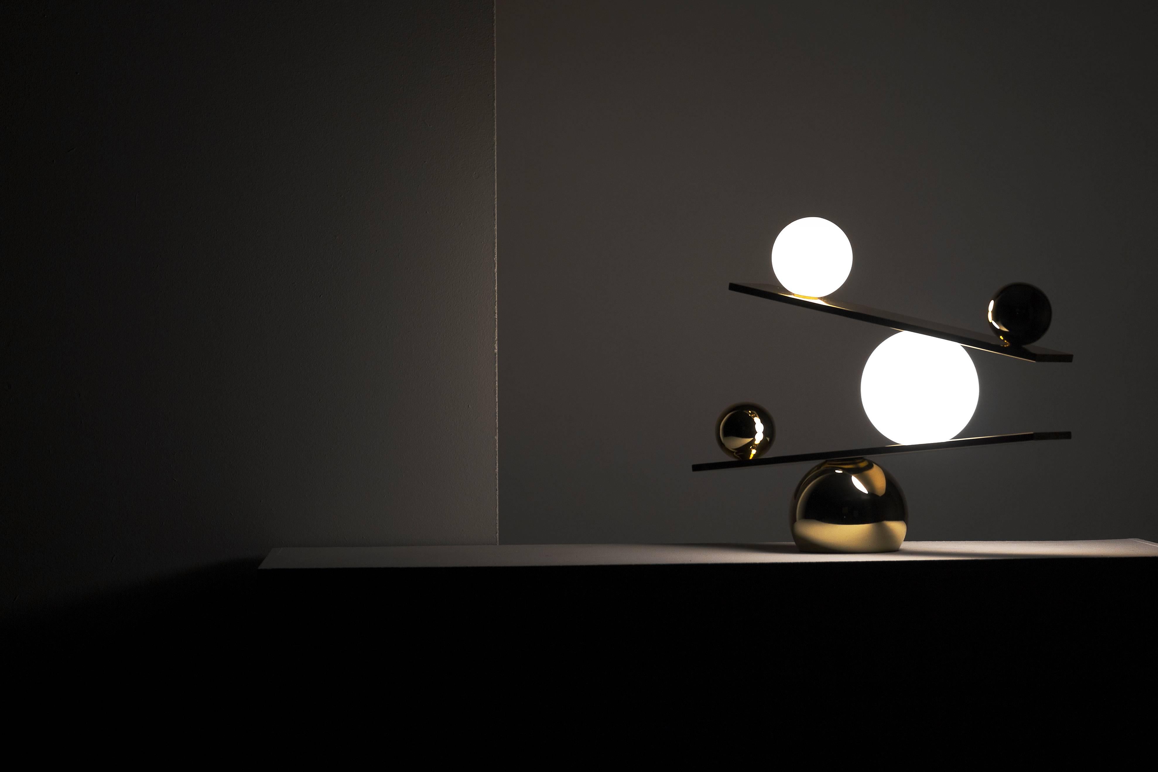 The Balance table lamp is Victor Castanera first product for Oblure. The fixed impossible position of the orbs is an expression of the fragility of existents. All entities move and nothing remain still. Balance is a play with the concept of time –