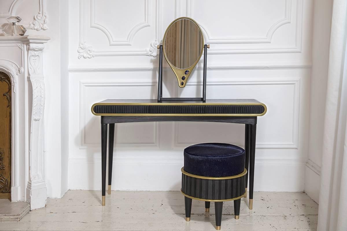 Oriette Dressing Table by Felice James

An alluring and striking dressing table with sodalite stone and brass accents.

MATERIALS
• Blackened oak
• Solid and liquid brass
• Corian
• Sodalite stones inset

DIMENSIONS:
Height 75cm x Depth 35cm x Width