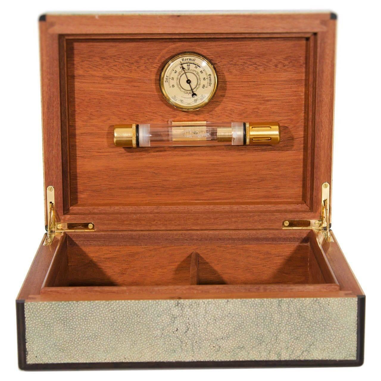 Made of such sophisticated materials as stingray skin, sterling silver and rosewood, this beautiful and rare cigar humidor with hydrometer of an outstanding workmanship features a remarkably simple and elegant design by the famous French