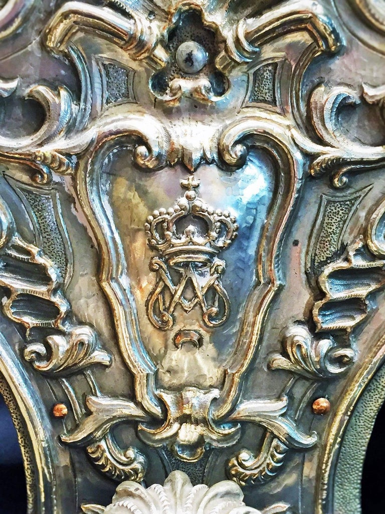 An amazing pair of 19th century hand-hammered silver double-armed candle wall sconces in the Spanish Baroque style. The back plates beautifully adorned with the Spanish royal crown and personal monogram of Amadeo I, the King of Spain. The heraldic