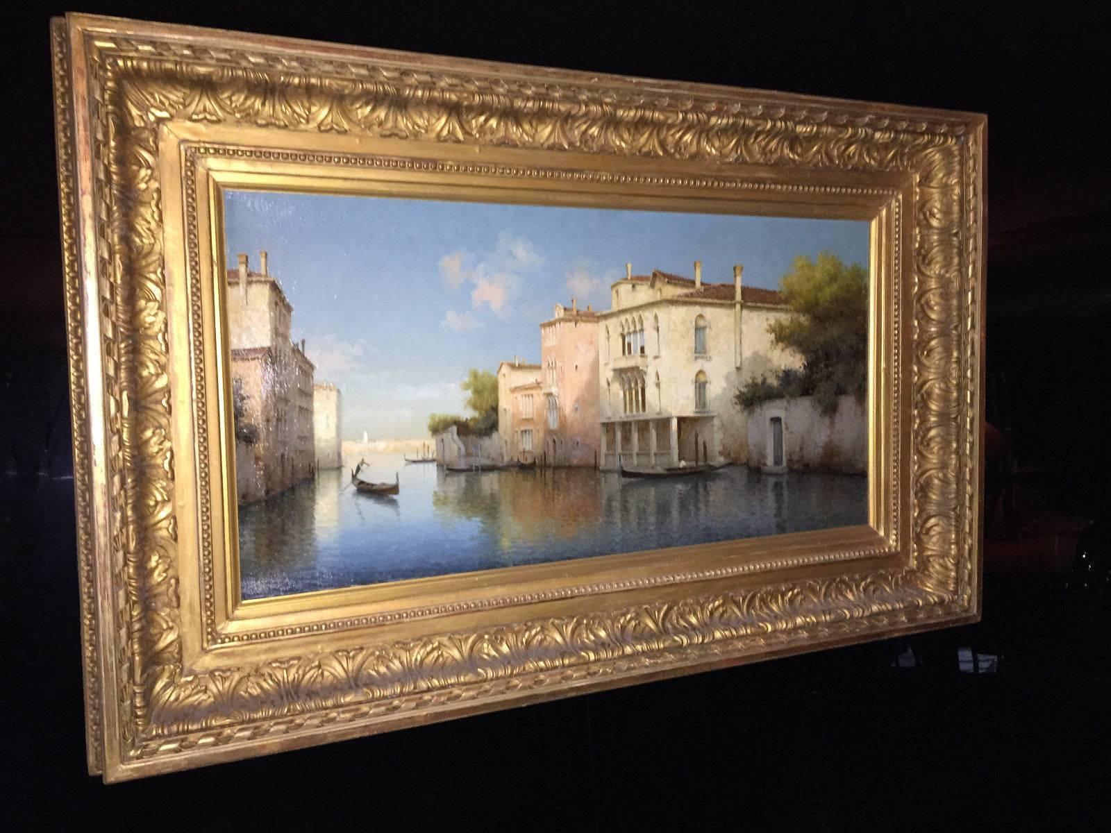 This original oil on canvas painting depicts a quiet summer morning, and a single Gondolier moves elegantly through a Venetian waterway, on his way to pick up a precious cargo of lovers. A blissful blue sky scattered delicately with clouds envelopes