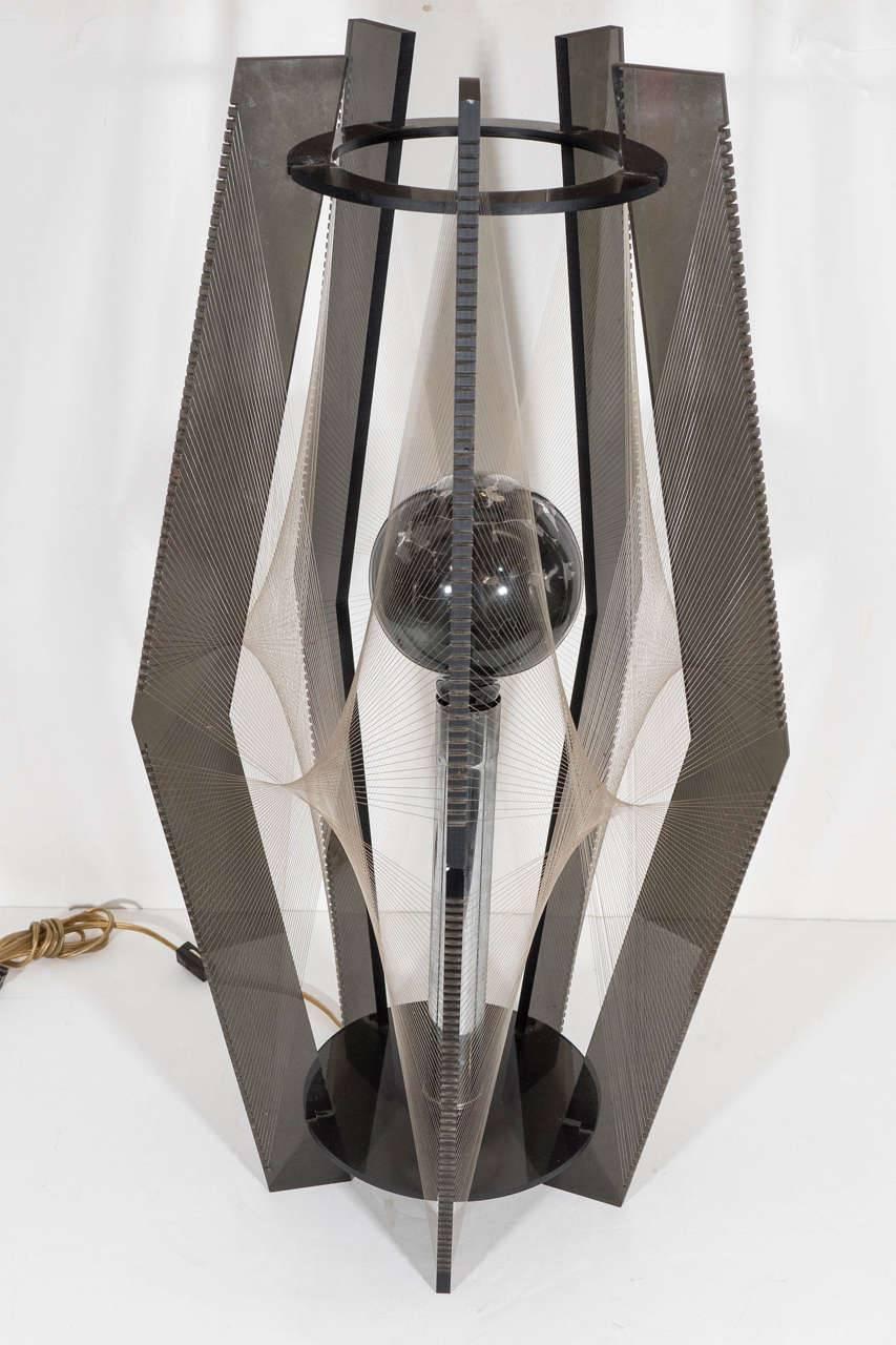A pair of vintage American table lamps, likely intended for a club or lounge, produced circa 1980s, with central chrome stems, surrounded by five smoked Lucite panels, joined by two circular supports to the top and bottom, surrounded by a layer of