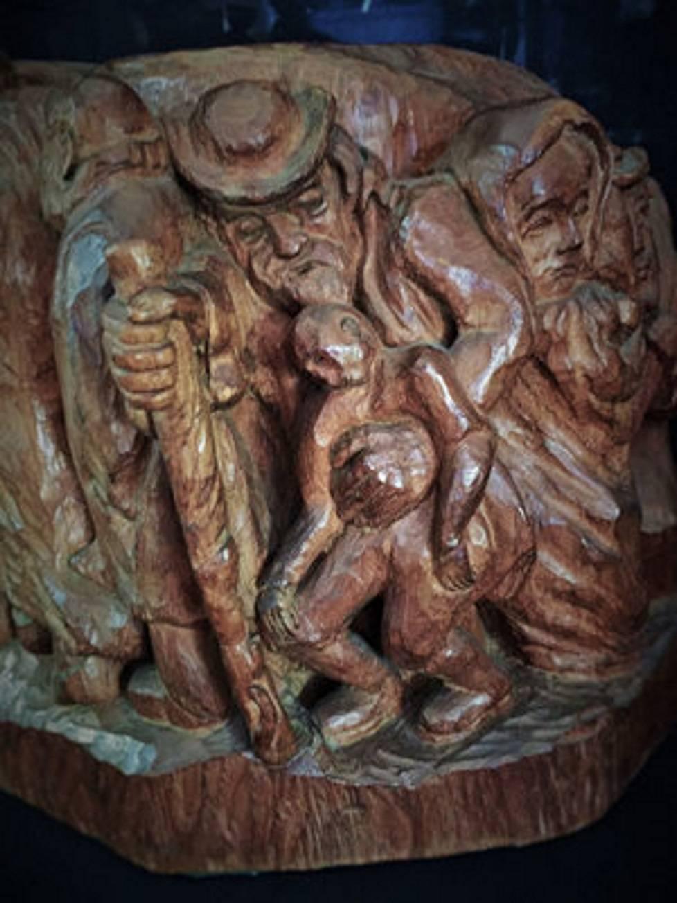 Extremely interesting for its unique expressiveness and masterful execution, this contemporary sculpture is carved from a tree trunk in its entirety. It depicts a crowd of closely huddled Jewish women, children and the elderly, their postures and