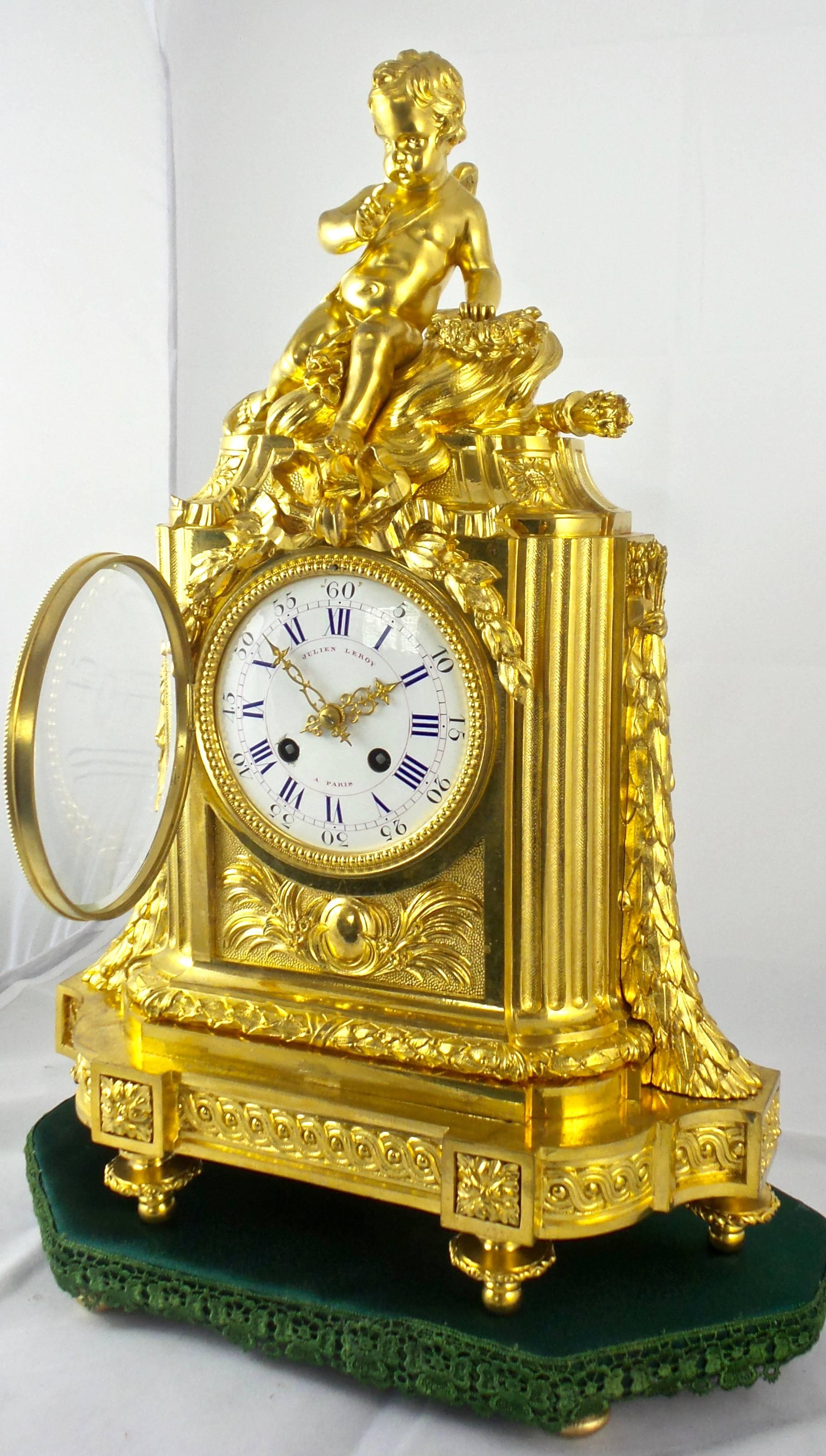 Impressive palace quality French Empire mantel clock by Julien Leroy of Paris
Fine adornments and detailed patterns and drapes with Cherub seated on top 
Convex porcelain dial with fine gilt hands and convex bevelled glass door
Bevelled glass