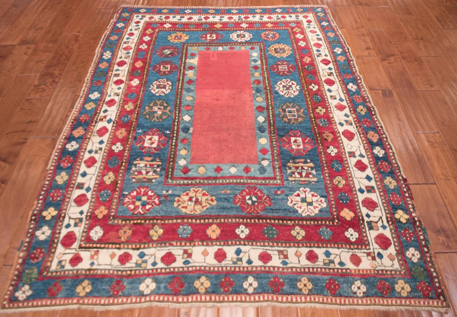 Early Kazak example of a Lambalo type. Lovely balance piece with unusual fuchshine dyed field color. All natural dyes with beautiful soft lustrous wool.
Violet red field likely produced from cochineal dye. Indigo blue in the border
Lovely