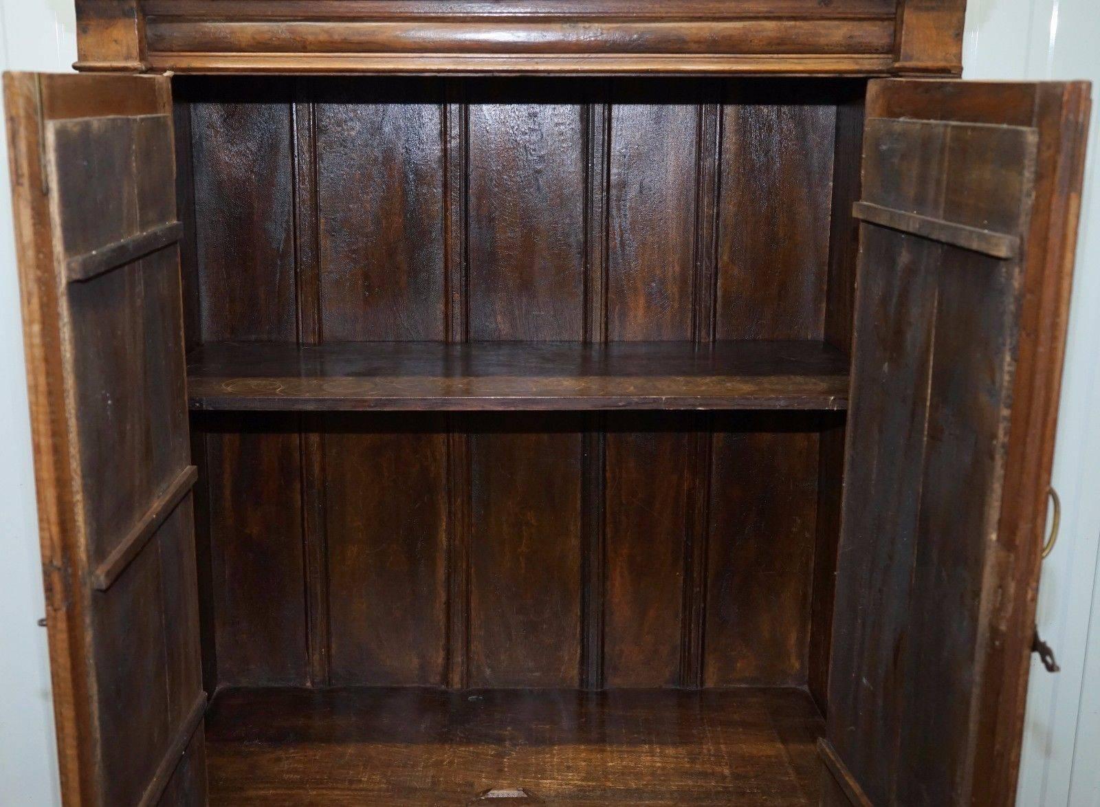 We are delighted to offer for sale this lovely solid hand-carved teak cupboard with mirrored doors

A rare and very substantial find, the timber is thick, hand cut and carved with a lovely rich warm patina, each panel is very chunky and
