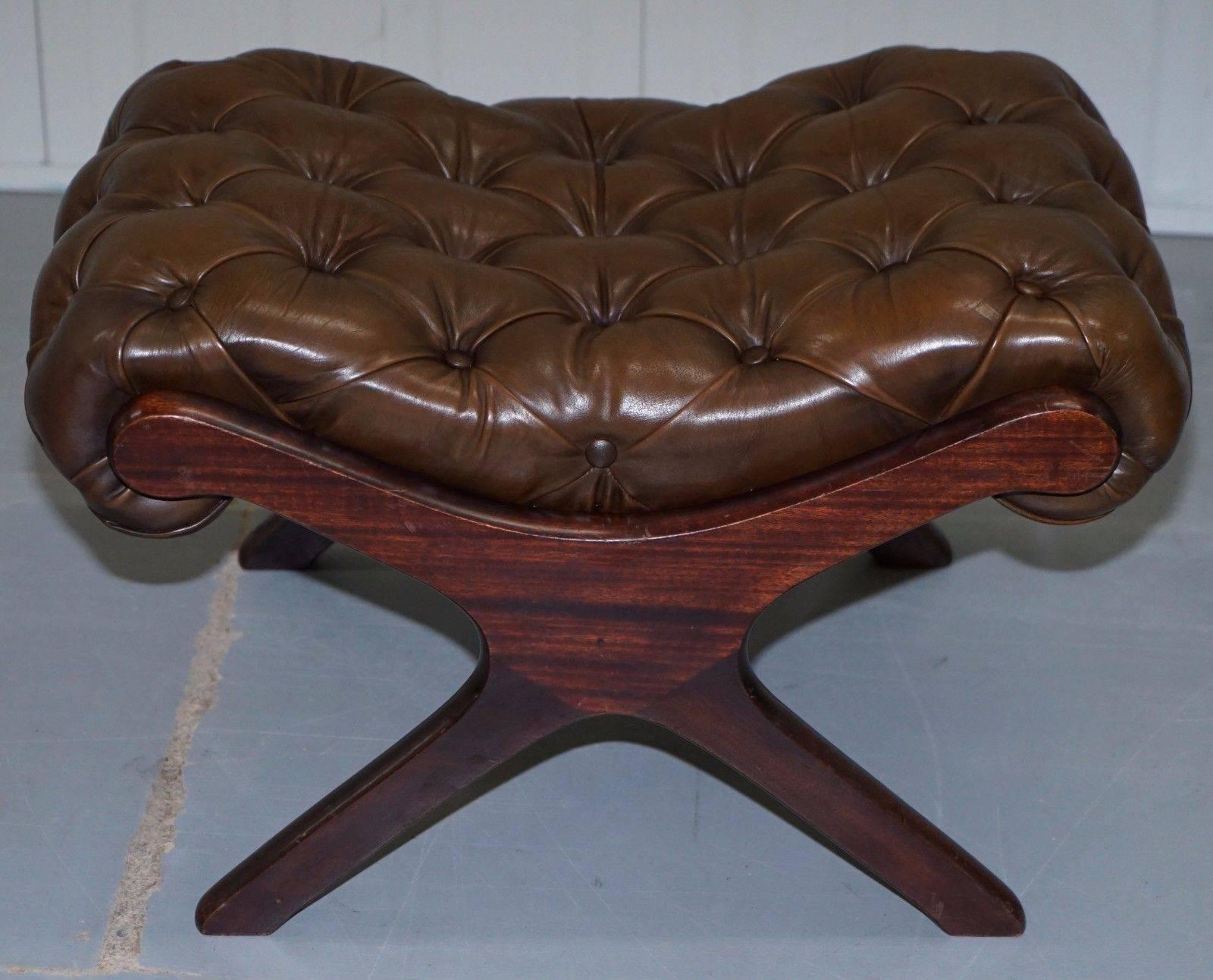 We are delighted to offer for sale this matching pair of stunning vintage aged brown leather full sized Chesterfield footstool/ottomans

A really good looking vintage pair with solid mahogany frames and overstuffed heritage leather upholstery,