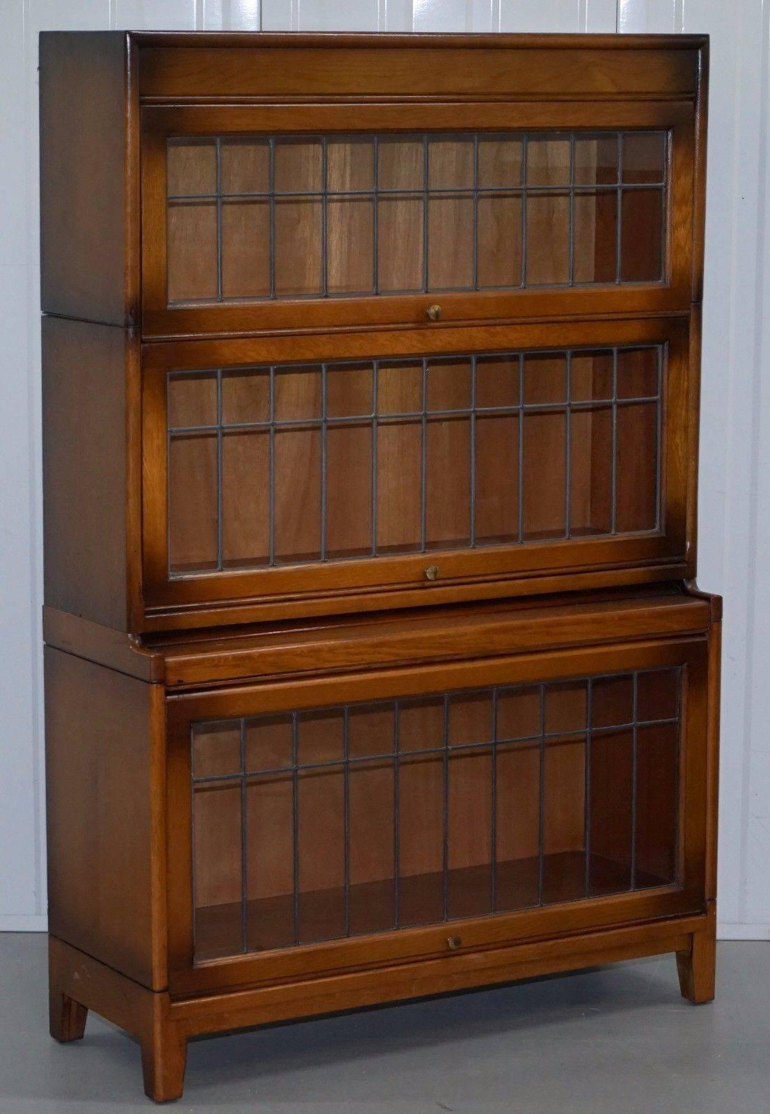 We are delighted to offer for sale this pair of Angus model by Gunn oak stacking library solicitors bookcases

A lovely well-made pair of retractable doors, the frames are solid oak the glass is free from cracks and damage and is lead lined
 
We