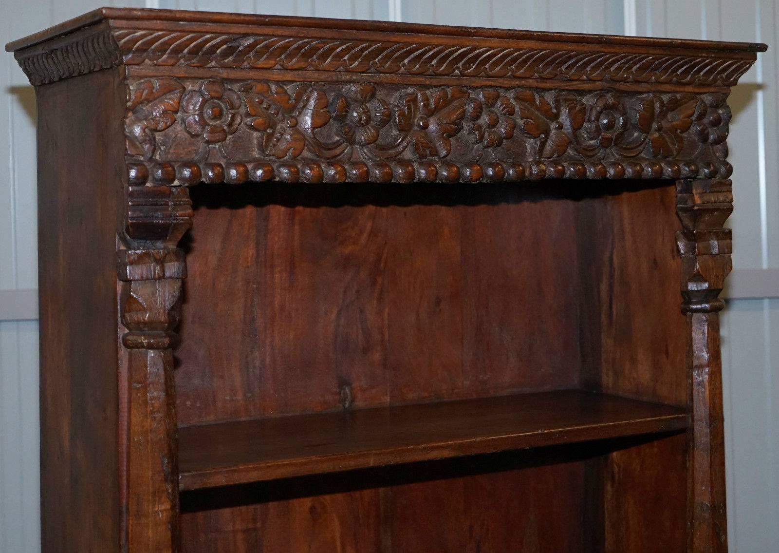 We are delighted to offer for sale this absolutely stunning hand-carved solid teak wood vintage bookcase

An exquisite and well-made thing that is just about as solid as you could possibly hope for

We have lightly cleaned hand waxed and hand