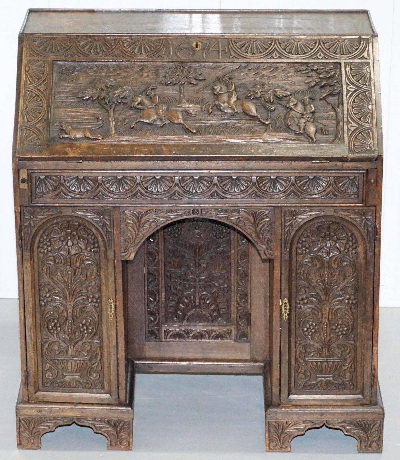 Wimbledon-Furniture is delighted to offer for sale this stunning original Charles II 1674 carved oak bureau depicting a hunting scene

Where to start, what a stunning rare find, the condition for the age is excellent, there are naturally a few