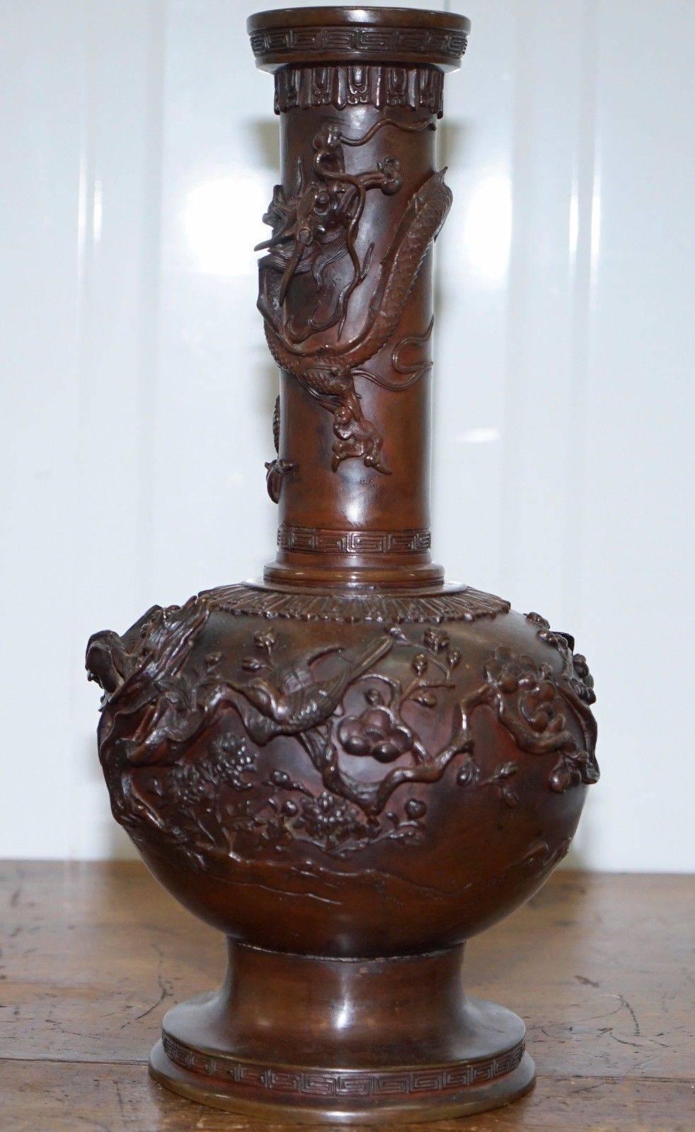 We are delighted to offer for sale this lovely pair of patinated bronze Meiji dynasty heavily detailed Japanese vases signed to the base

A very good looking and well-cast pair, the Dragon relief detail is stunning, the dragons head circles the neck