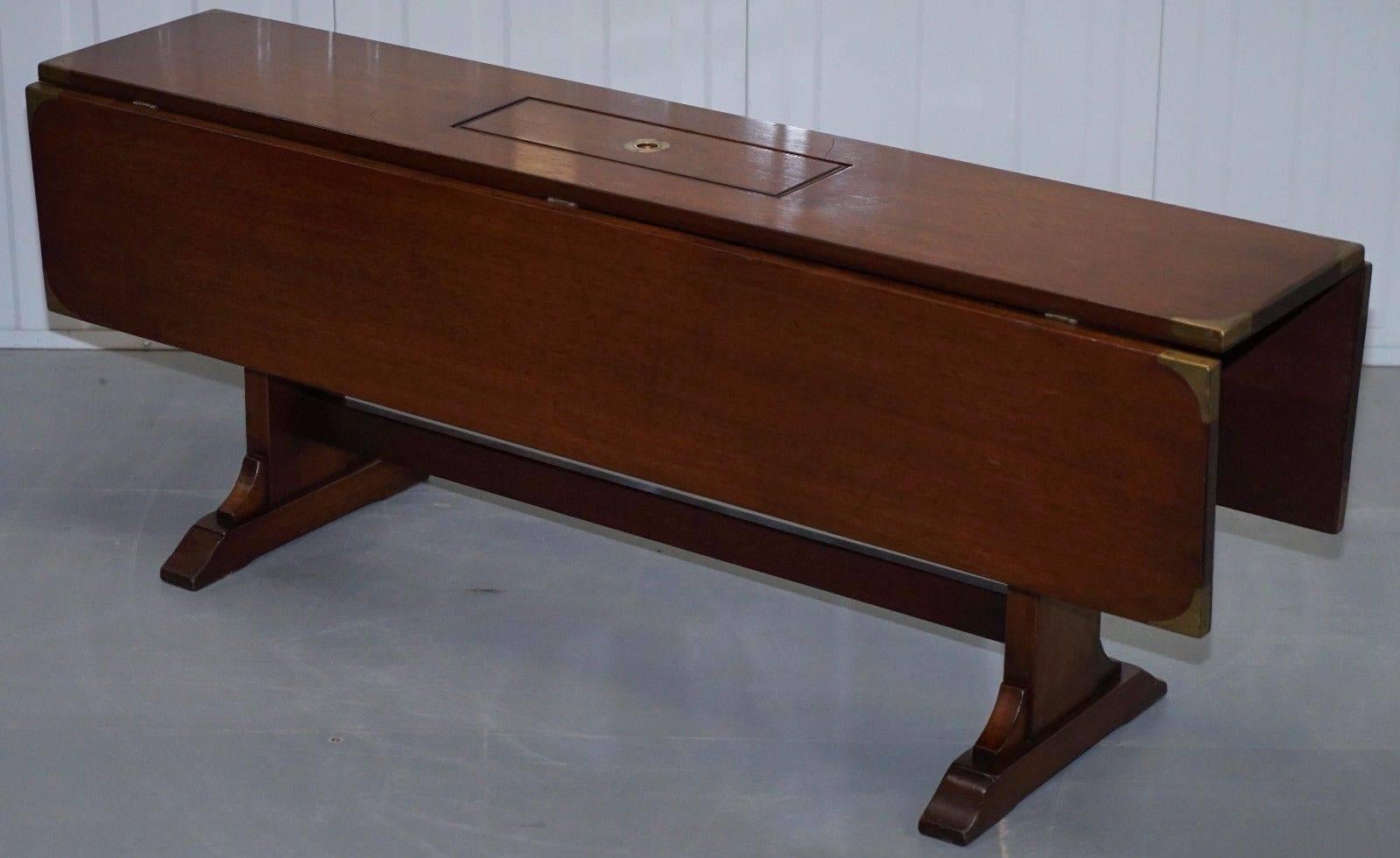 We are delighted to offer for sale this stunning extending military campaign coffee table made from solid mahogany and fitted with brass hard wear

A very good looking piece in pretty much perfect unmarked condition, the brass fittings are nice