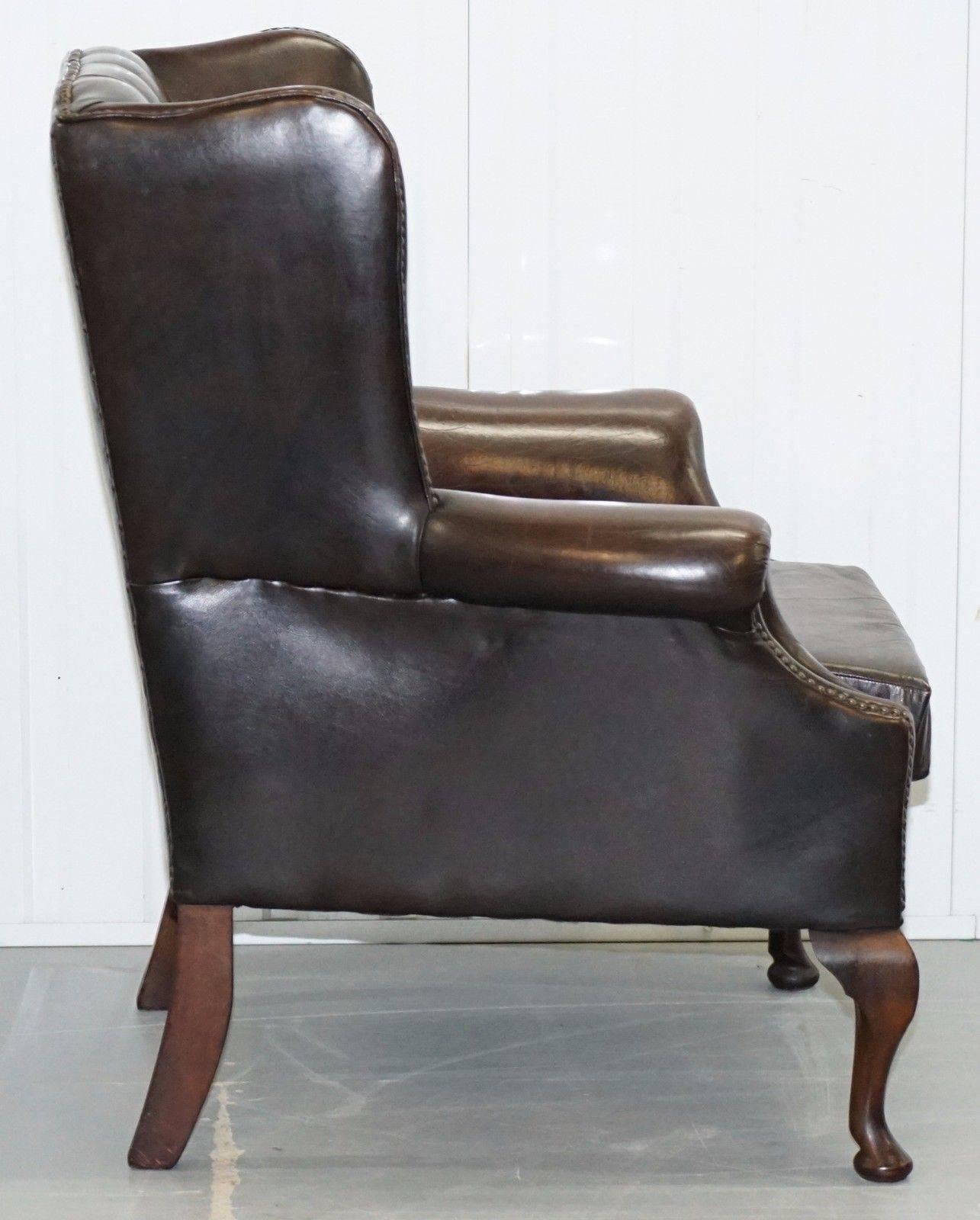 Victorian Pair of 1960s Aged Brown Leather Chesterfield Wingback Armchairs and Footstool