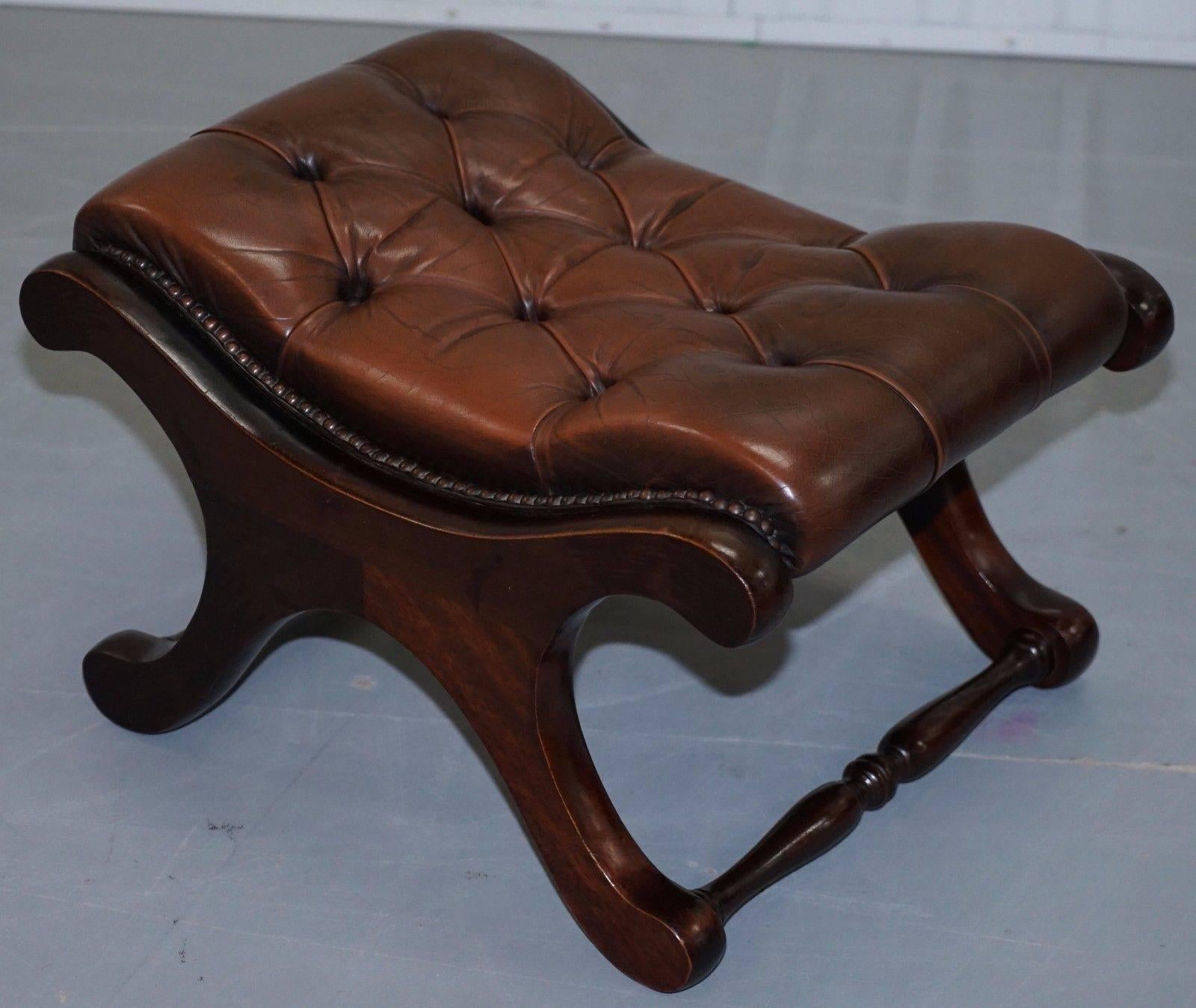Mid-20th Century Pair of 1960s Aged Brown Leather Chesterfield Wingback Armchairs and Footstool