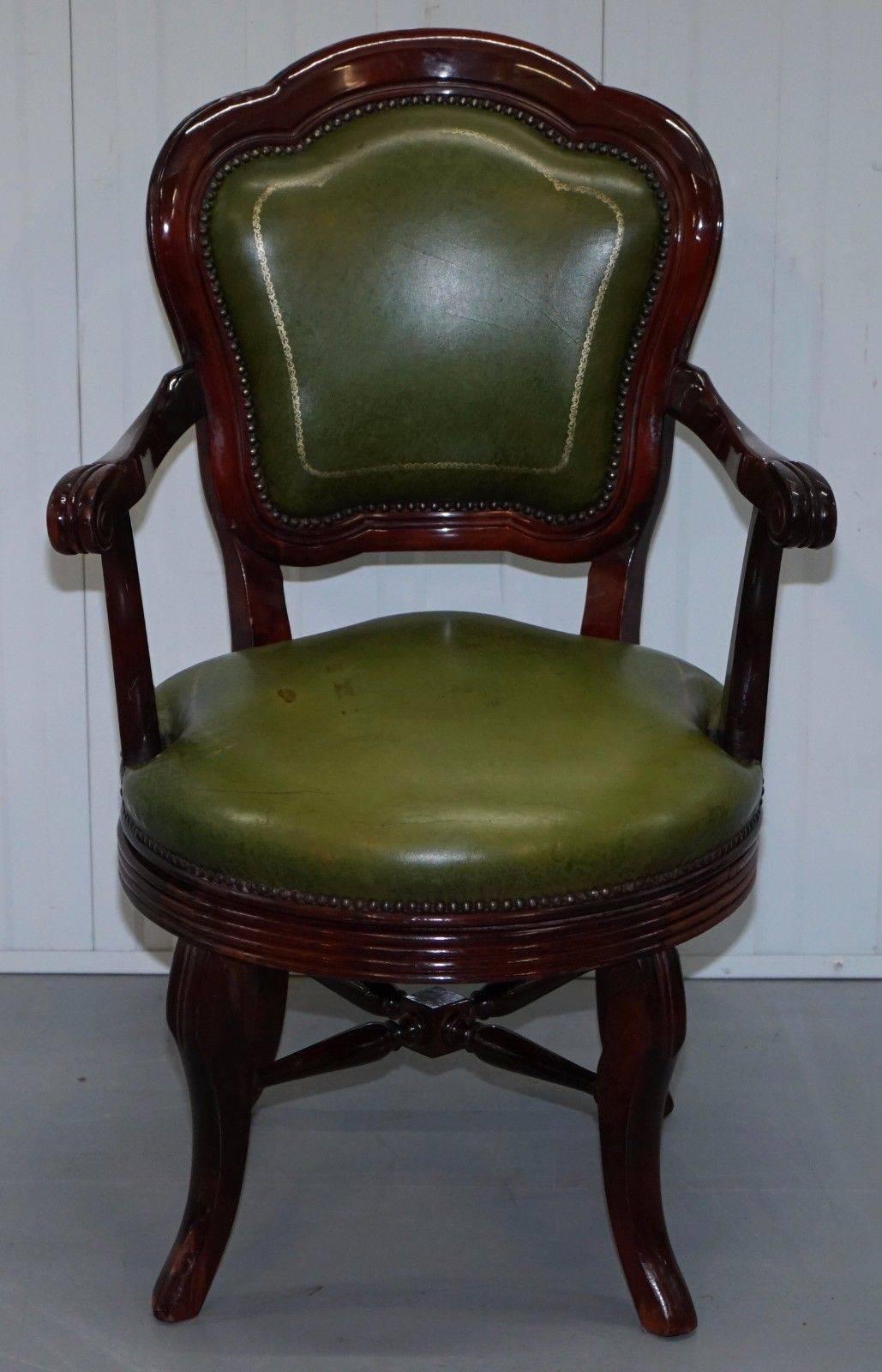 We are delighted to offer for sale this vintage aged green leather with gold tooling and mahogany frame office swivel chair

A really good looking and comfortable vintage chair, the base sits on an old fashion rail swivel system, it’s just about