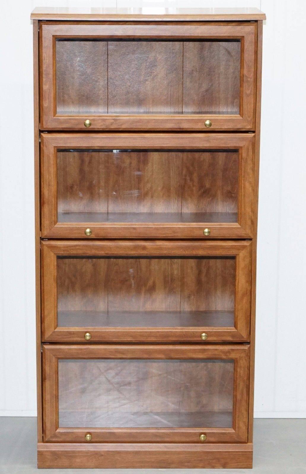 We are delighted to offer for sale this lovely perfect condition folding glass door legal bookcase

A really good looking and well-made piece in near perfect condition, the glass doors lift up and slide into the frame, ideal for small spaces

