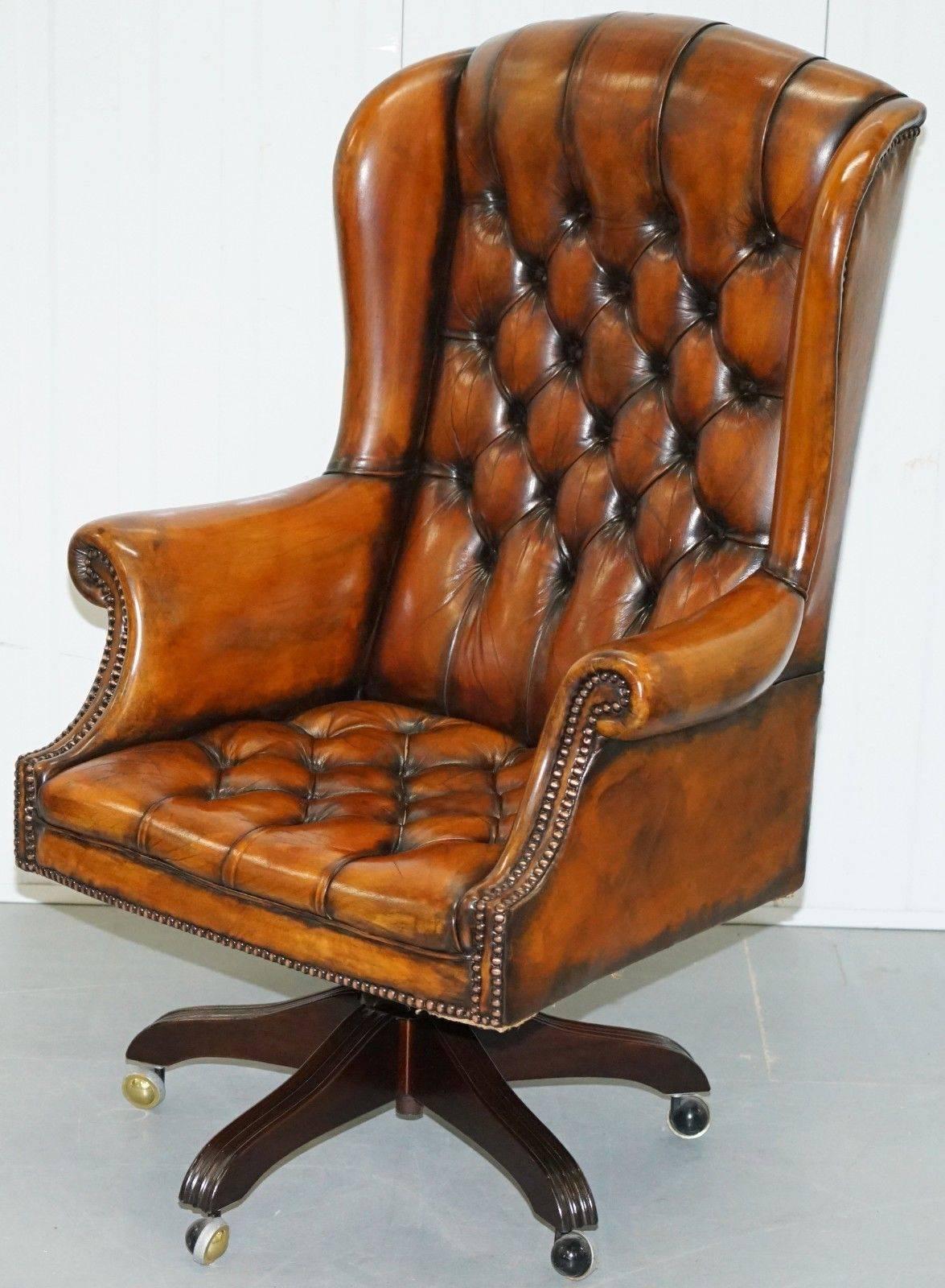 We are delighted to offer for sale this stunning pair of very rare fully restored hand dyed Whisky brown leather Chesterfield wingback office swivel armchairs

This auction is for the one chair with the option to buy the pair, so the price is per