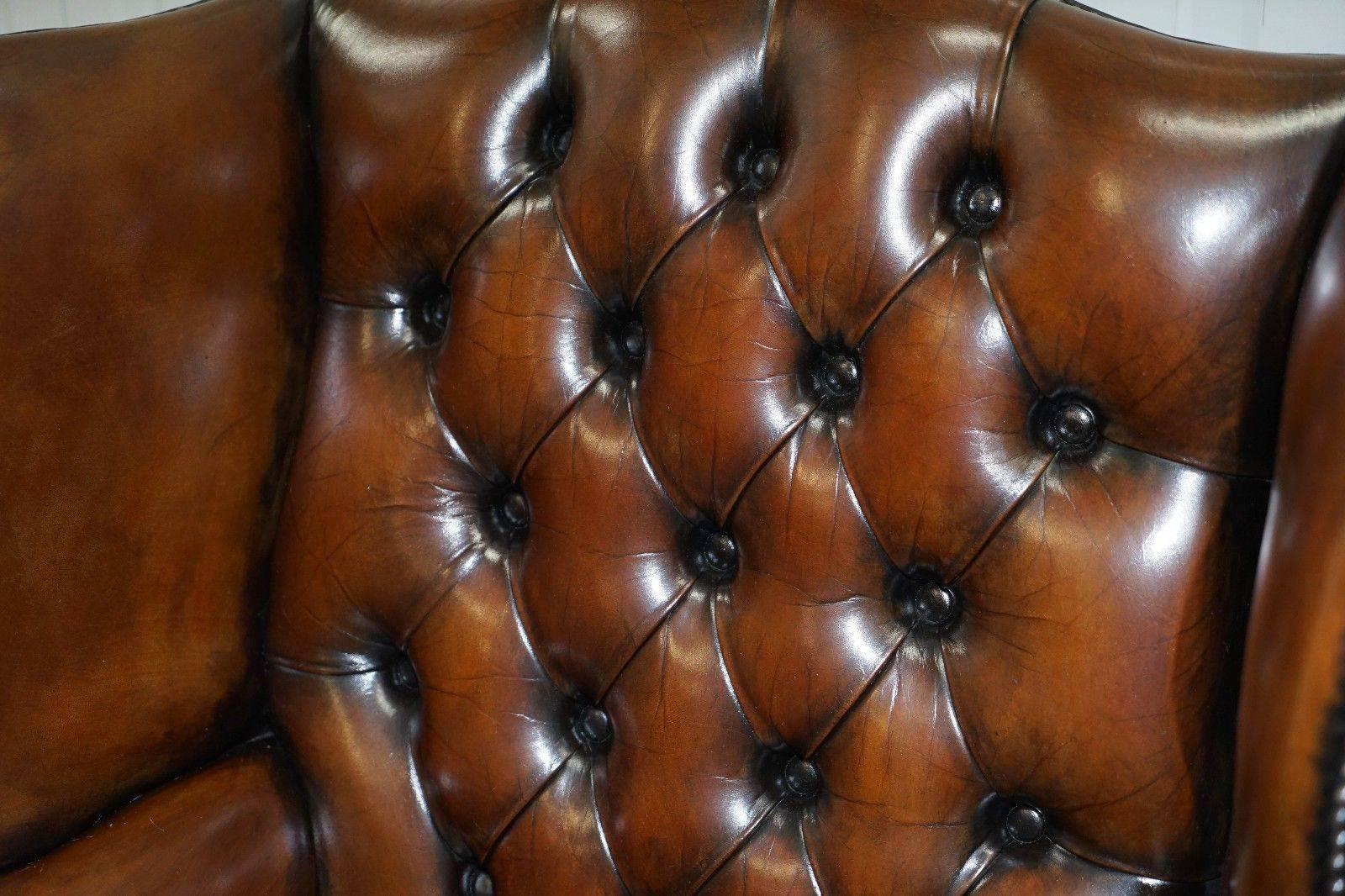 British Pair of Hand-Dyed Cigar Brown Leather Chesterfield Wingback Armchairs and Stool