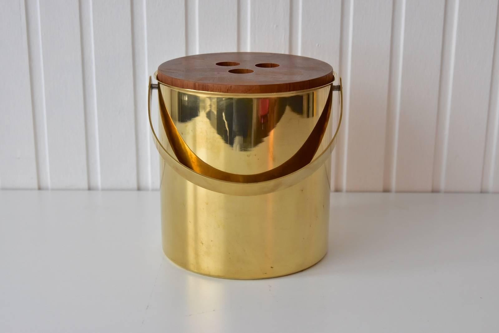 Arne Jacobsen for Stelton ice bucket and tongs. The large ice bucket and tongs are done in brass and teak wood from Stelton.