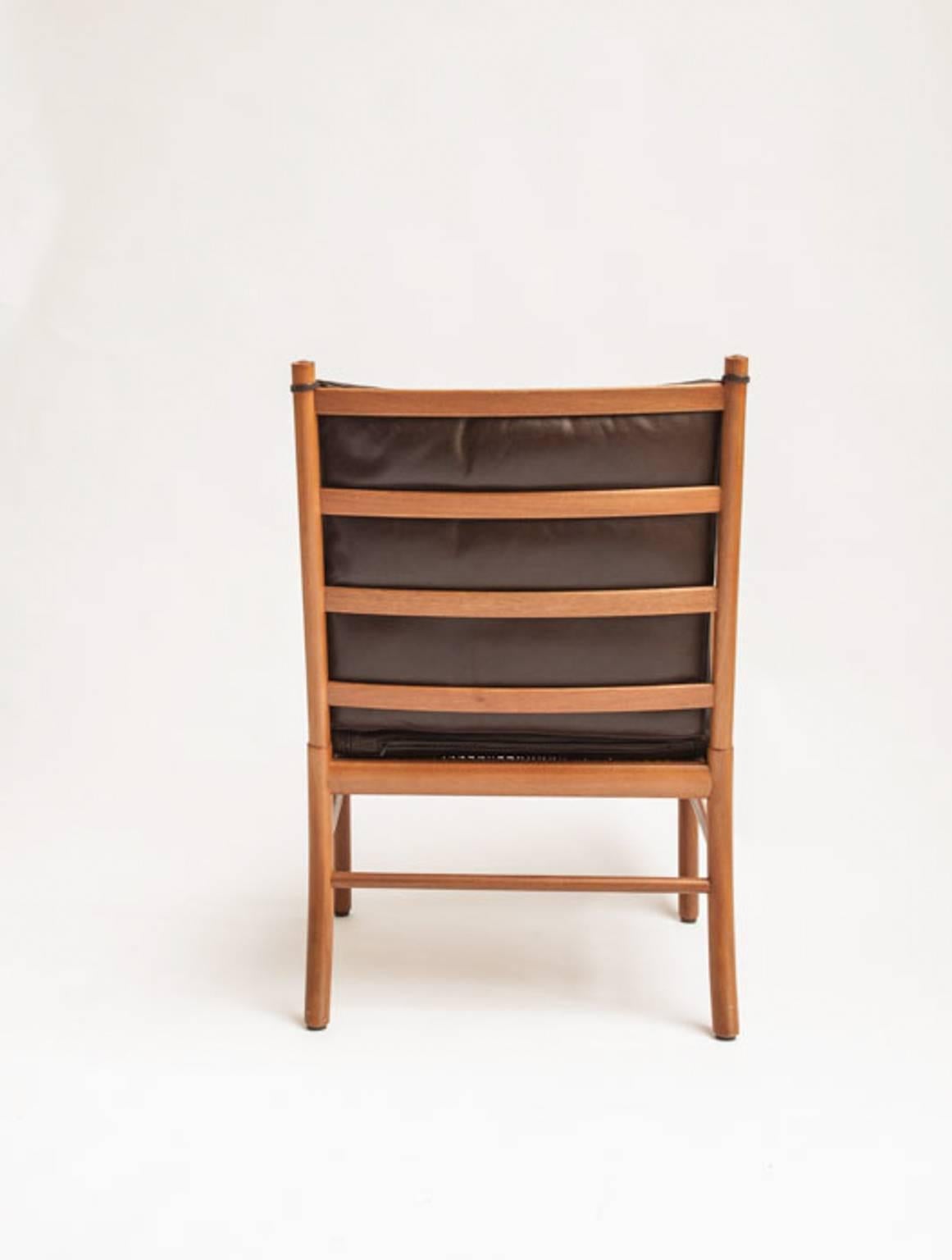 Beautiful vintage Colonial chair, model PJ 149. Lounge chair with mahogany frame. Woven cane seat. Back and seat cushions filled with down, and upholstered in dark brown leather. Designed in 1949. Produced by P. Jeppesens Møbelfabrik in
