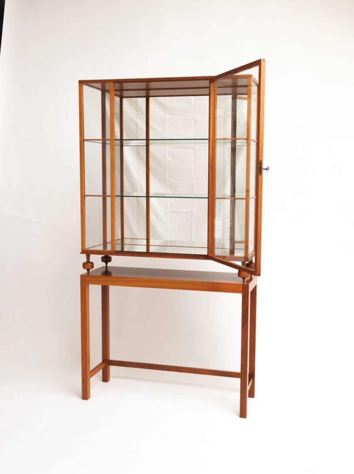 This beautiful display cabinet, model 2077, is one of Josef Franks most remarkable designs. It is made of solid mahogany, with glass sides and doors. Base and back in mirror glass. Designed for and produced by Company Svenskt Tenn. Brand stamped.