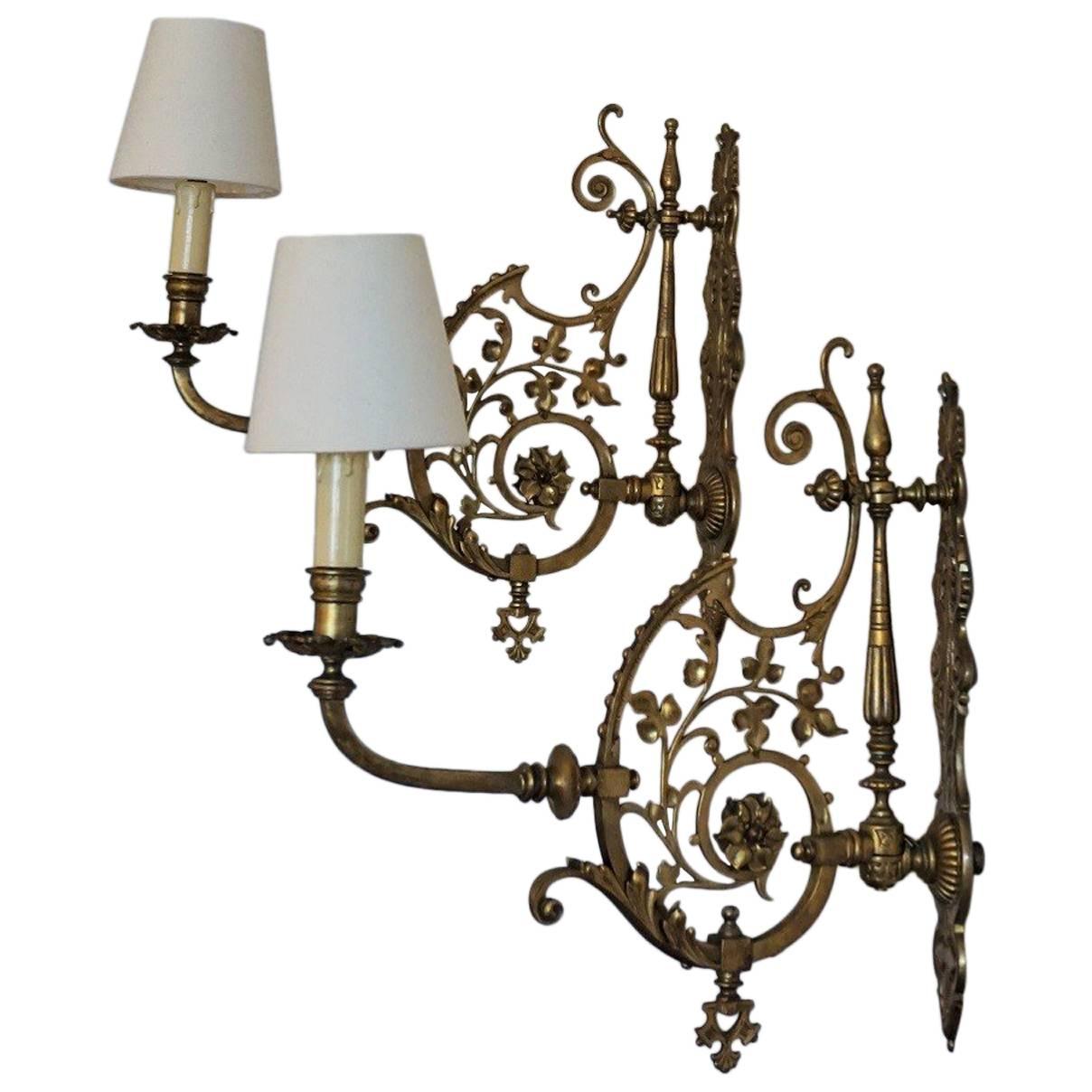 French Art Nouveau pair of bronze and brass wall sconces richly decorated with floral motifs with new ecru cotton shades. 
One E14 bulb socket
Measures:
Height with shade: 16.50 in (42 cm / without shade: 15.50 in (39 cm)
Depth with shade: 15.75 in