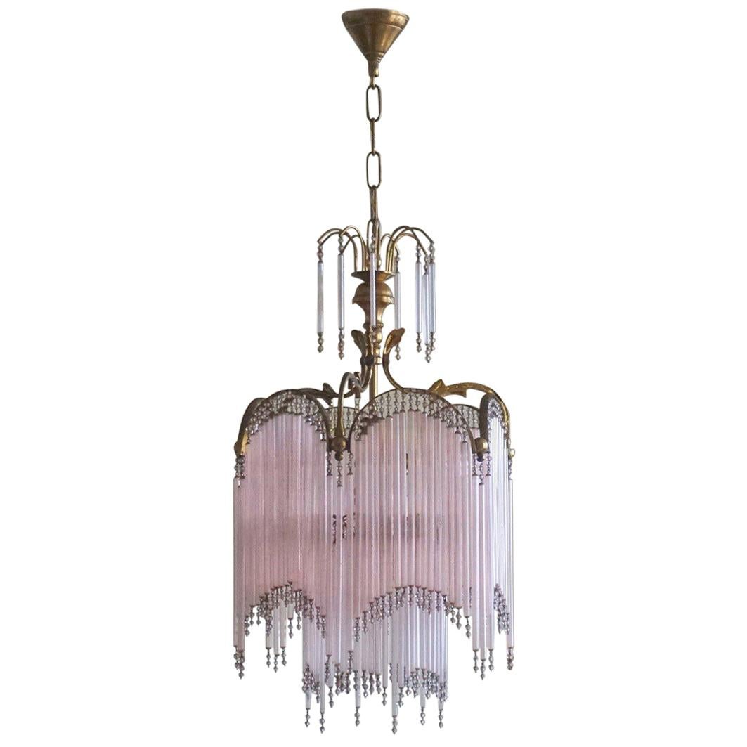 A lovely cascading rose glass rod and brass chandelier, beautiful lighting effects!
Height with chain and canopy: 34.50 inches (87.5 cm) - variable height
Height without chain and canopy: 23 inches (58.5 cm)
Diameter 12.50 inches (32