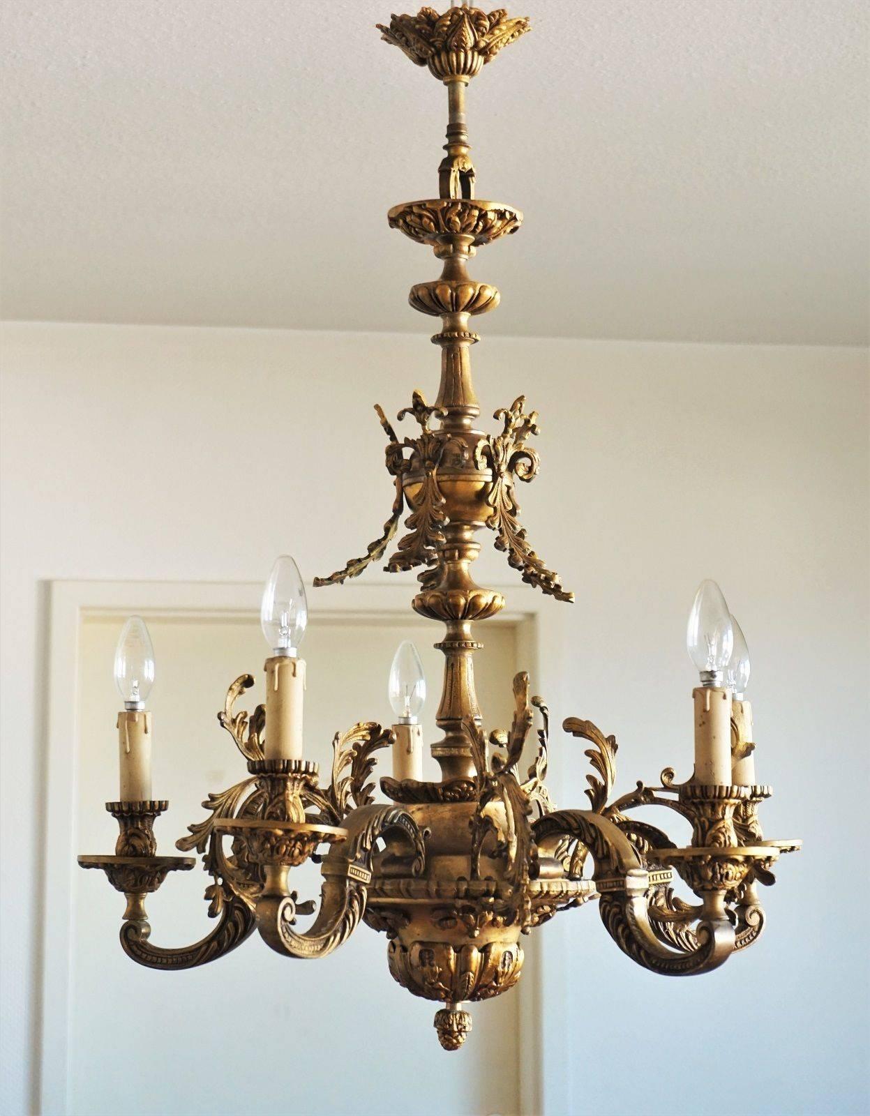 Louis XVI style solid gilt bronze five-arm chandelier extremely ornate with great details, France, circa 1870-1880. Beautiful aged patina to bronze, rewired.
Five E14 bulb holders with candle covers sockets.
Measures:
Diameter: 27 in / 68.5