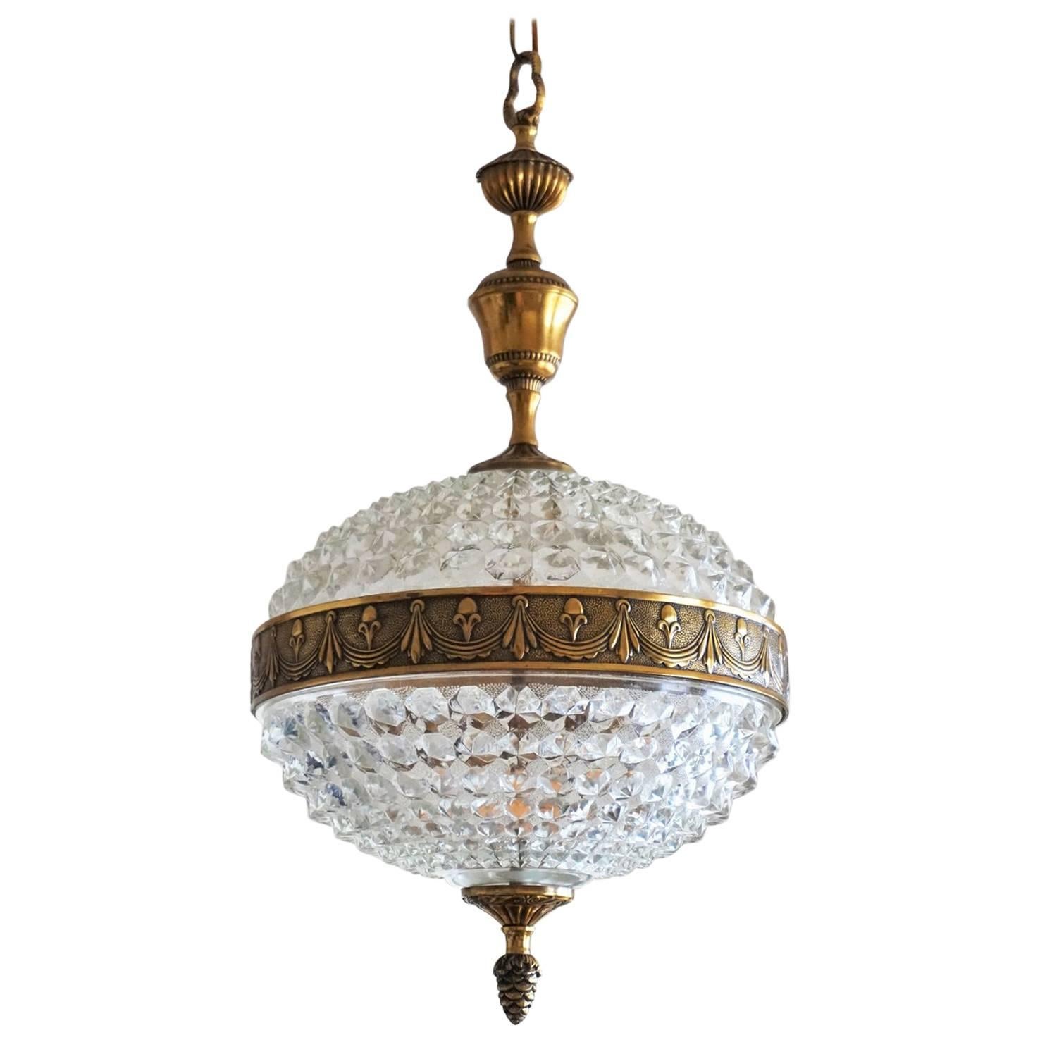 A lovely vintage glass ball and brass two-light chandelier from the 1960s

Measures:
Total height: 34 in (86.5 cm), adjustable height by exting or shortening the chain
Height without chain 23 in (58.5 cm)
Diameter 12.25 in (31 cm)
Takes two E14