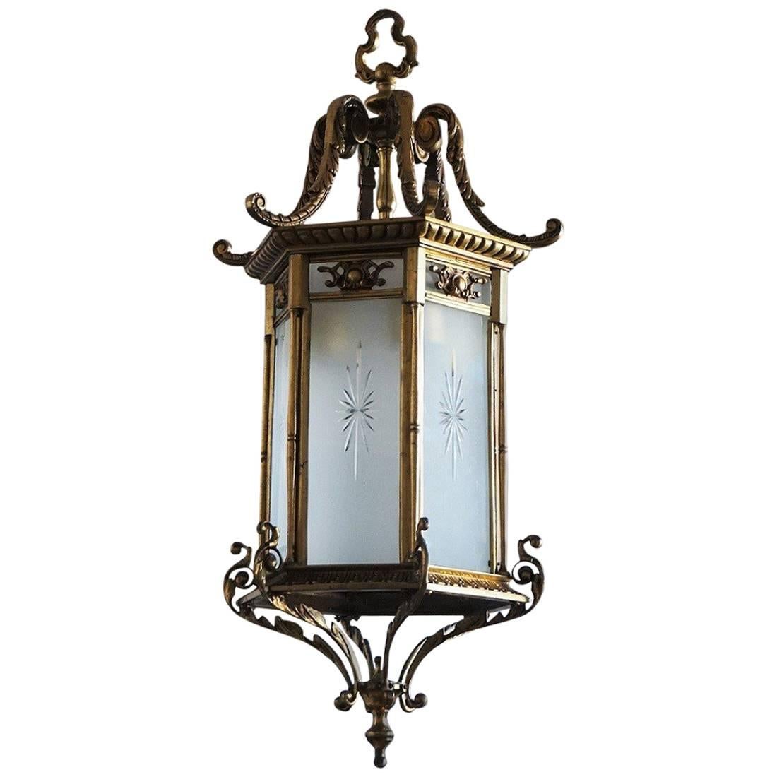 Heavy, large Regency style lantern, France, circa 1870-1880. This lantern is of solid bronze and parcel brass with six frosted cut glass windows. The lantern arrives with beautiful solid bronze canopy and chain. 
Number of lights: Two E27 light