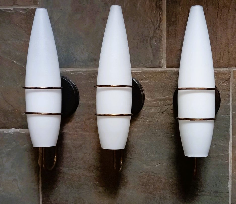 Set of three rare, tall wall lights Stilnovo style, Italy, 1950, modernist and clear lines design, brass galery with satin white glass shades. All three sconces in good original vintage condition, brass with some wear and aged patina,  no damages,
