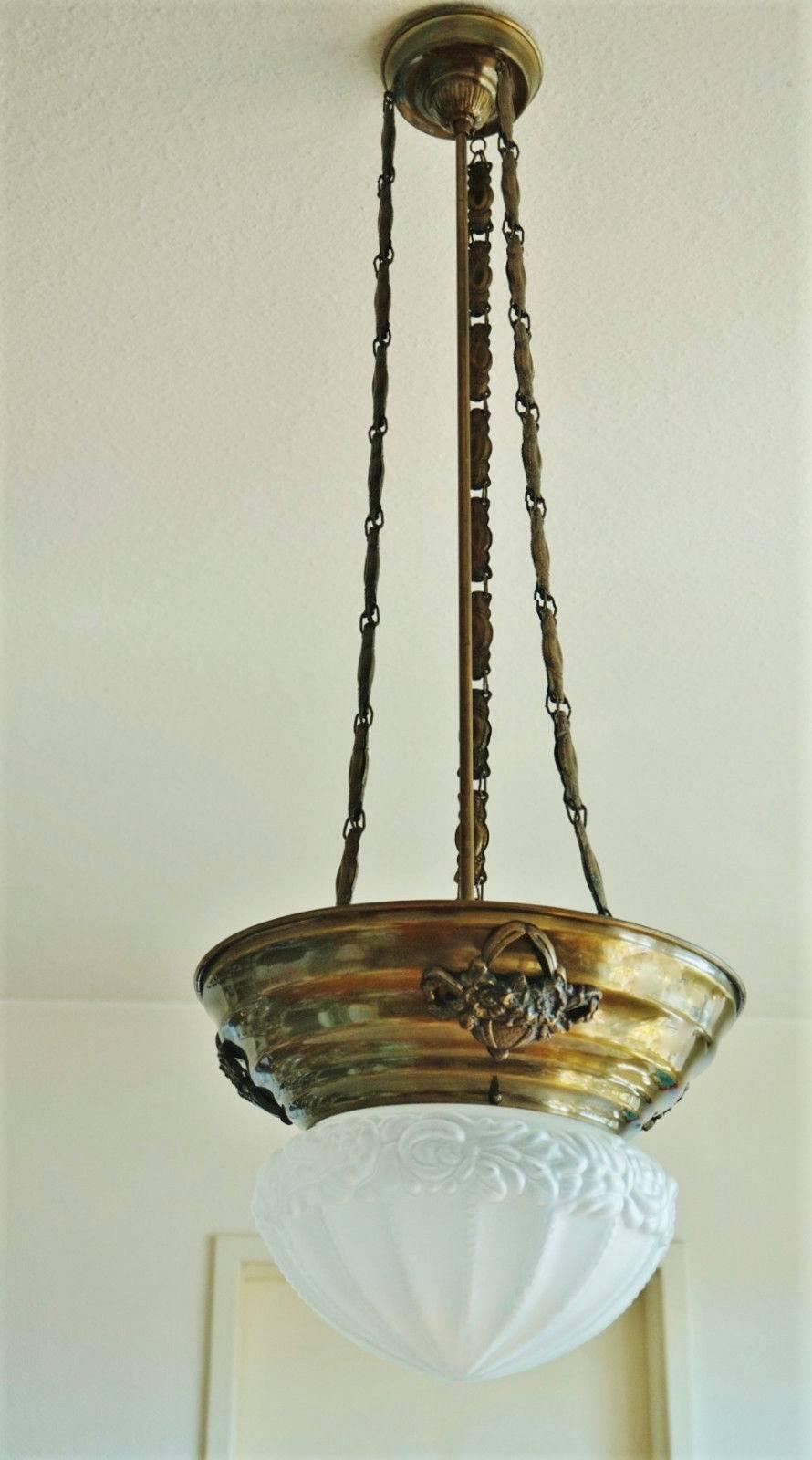 Art Nouveau style brass two-light pendant with superb long chains and large frosted glass shade with flowers in high relief.

Height: 41½ in / 106 cm
Diameter: 14½ in / 37 cm
Two lightt sockets 