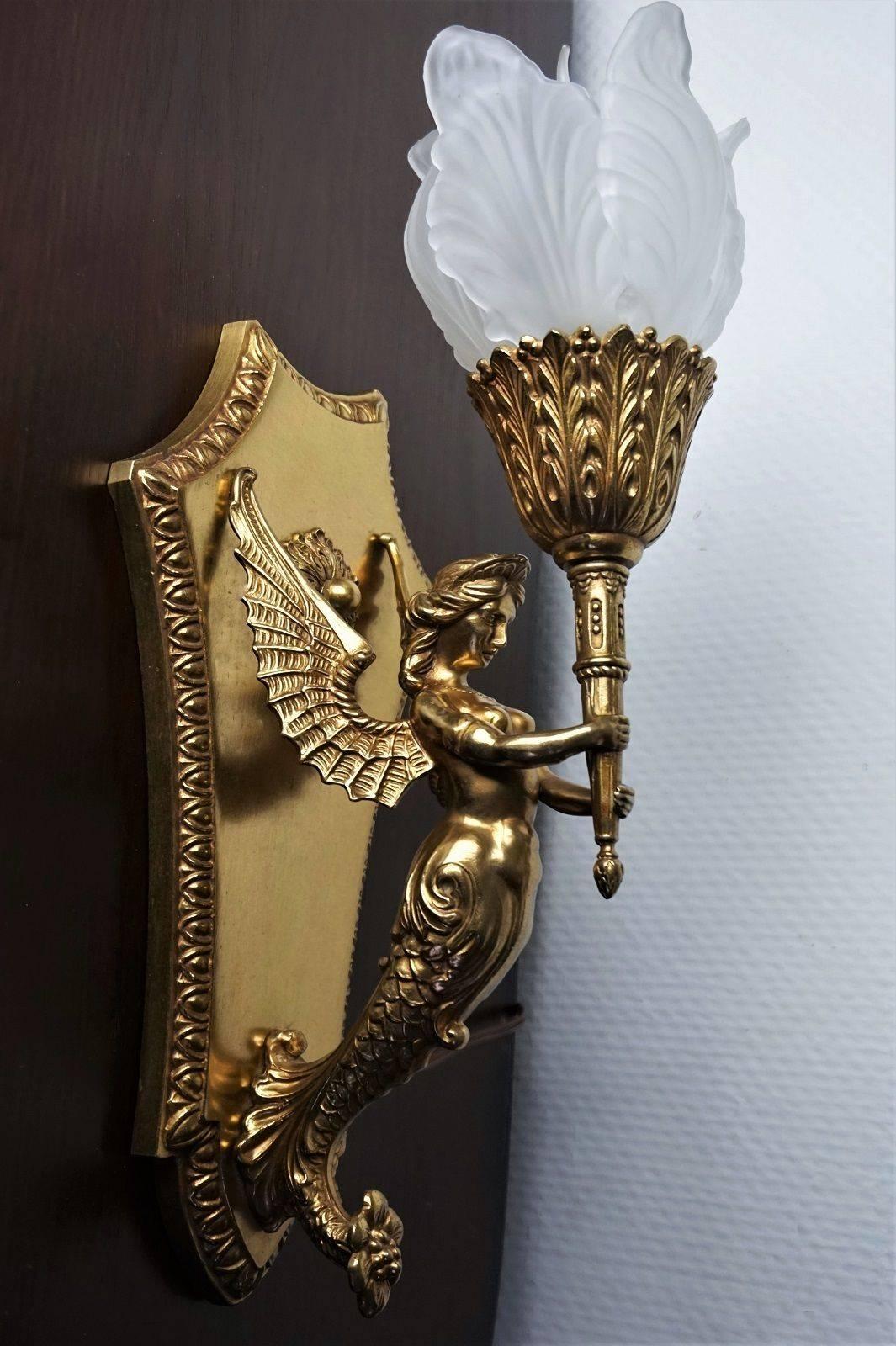 Heavy French Empire chased and gilt bronze winged figural wall sconce, France circa 1880-1890, with flower glass schade (the glass flower is composed of five separated petals).

This piece has been electrified at a later time.

Height with shade: 17