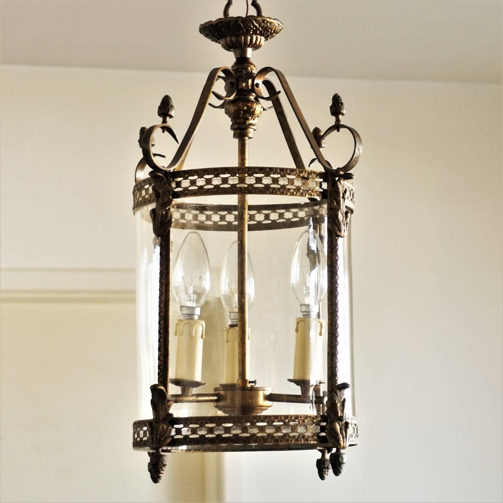 Art Nouveau brass three-light lantern, pendant with glass cylinder shade, circa 1910.

European wiring: Three x E14 lamp sockets
Measures: Total height: 39 1/2 in (100 cm)
Height without hanging chain: 19 3/4 in (50 cm)
Diameter: 11 in (28