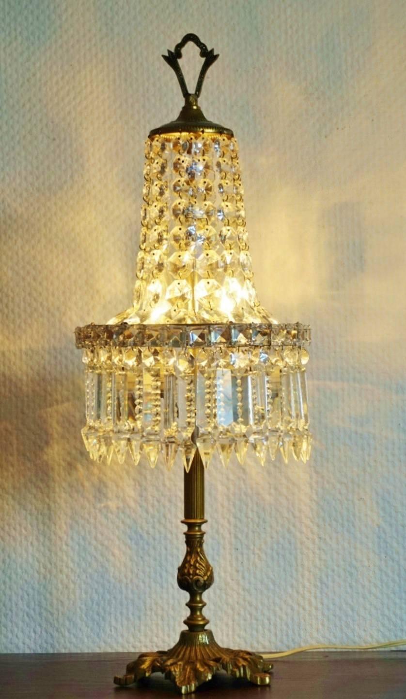 Vintage cut crystal and bronze two-light table lamp chandelier with impressive lighting effect, circa 1930.

Measures: Height 24 in / 61 cm 
Diameter 9 in / 23 cm
Base 6 in diameter / 15 cm.
Two light sockets
