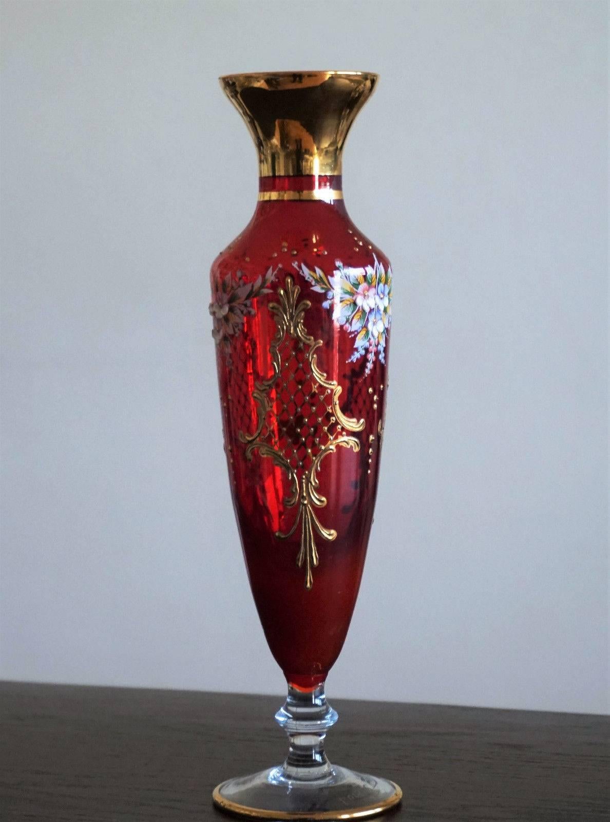 Elegant vintage Bohemian robin red art glass vase with 22-Karat gold gilded enameled hand-painted decor and floral motifs.

Very good condition, no chips or cracks

Measures: Height 10.65 in (27 cm)
Diameter 3.15 in (8 cm)

Marked "Luis