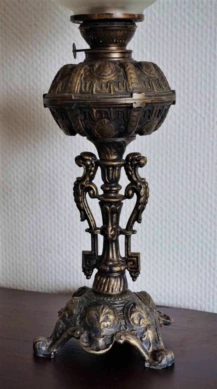 Large heavy cast bronze oil lamp converted to electric table lamp, richly ornate raised on column with three dragons. Etched glass globe and glass chimney, circa 1880-1890.

Very good condition, no chips or cracks, bronze with sighs of use and