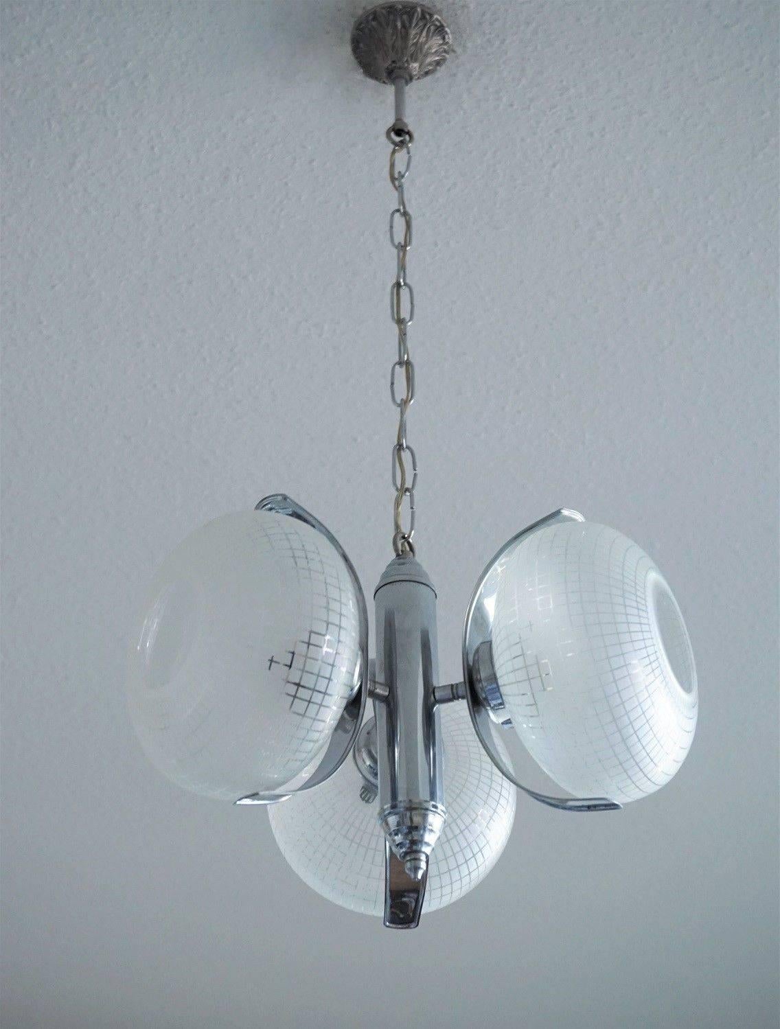 Space Age chrome-plated metal three-light chandelier with large frosted glass globes, Germany, circa 1960

Measures: Diameter 15.75 in (40 cm) 
Height 29.50 in (75 cm)

Three light sockets.