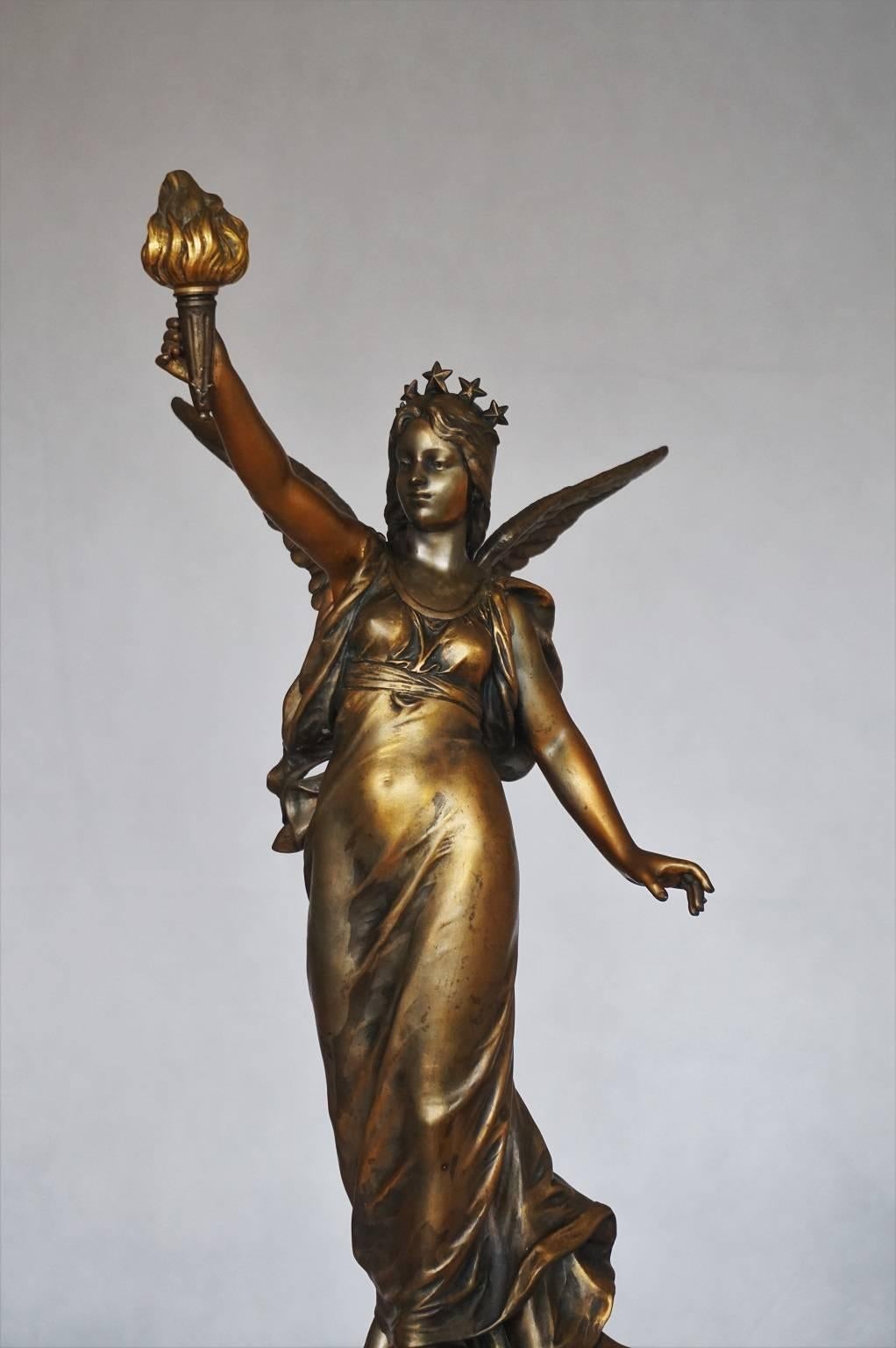 Late 19th century French bronze statue of a winged maiden holding a torch standing on a rocky, signed Bouret. The bronze is raising on a red marble plinth.

Measures: Height 27 ½ in (70 cm)
Width/Depth 10 in (25.5 cm).

         