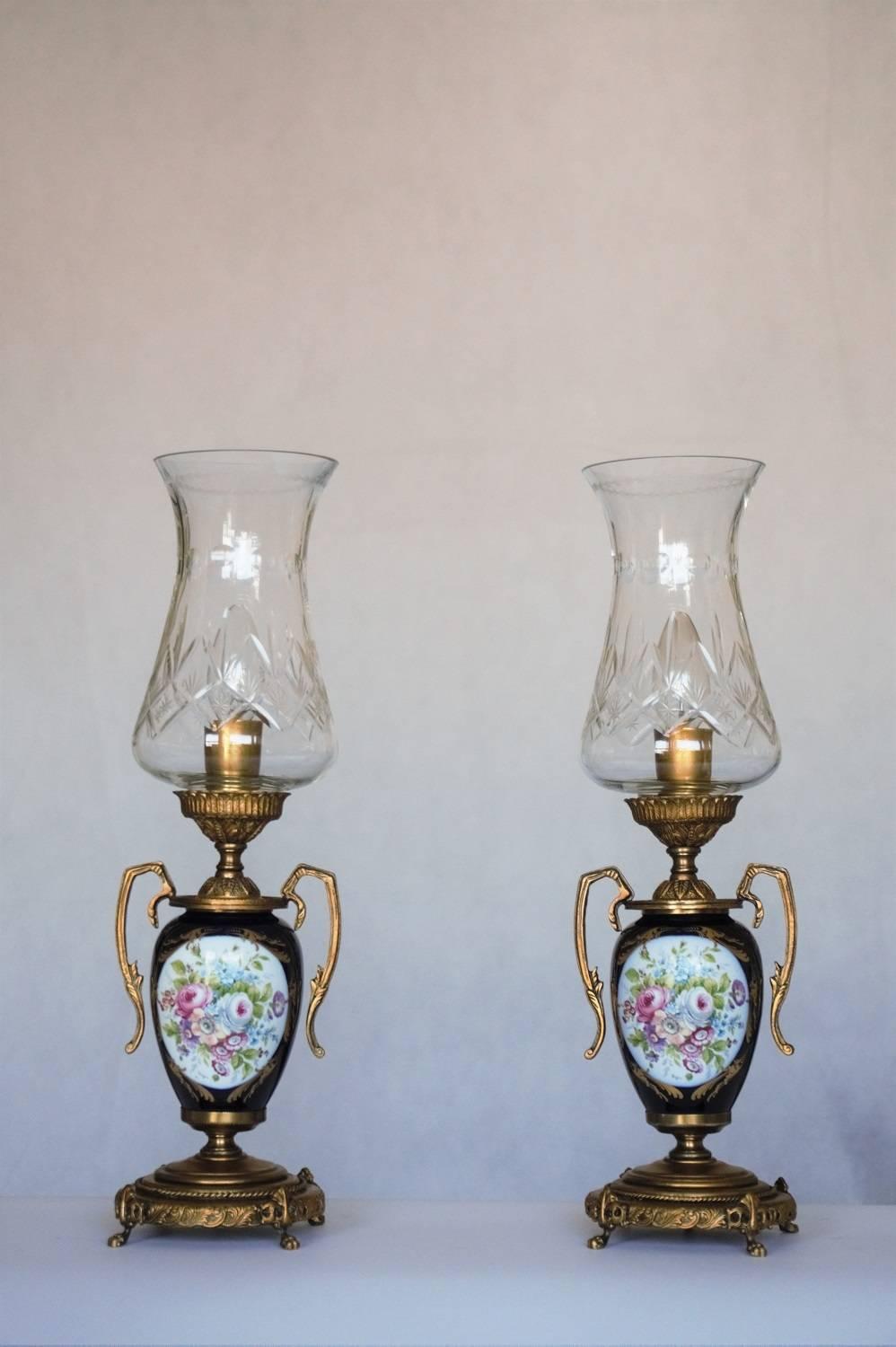 Pair of French cobalt blue porcelain and brass vase table lamps with hand-painted flowers and gilded decor, tall cut crystal lamp shades, circa 1950 1960.
Porcelain manufacture: ACE Decor De Paris / with signature of the painter

Very good