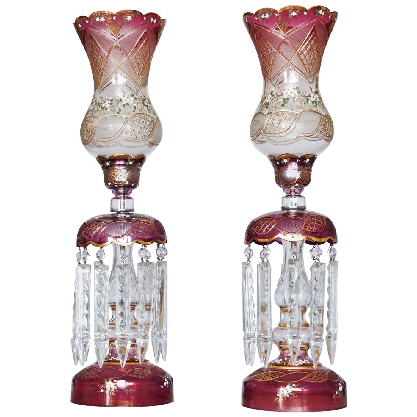 Pair of large Bohemian cranberry hand-painted cut glass lusters, table lamps with long cut glass prisms, circa 1920.

One light socket.

The lusters have been rewired - new electric cable

Measures: Height: 26 ¾ in (68 cm) 
Diameter: 7 in (18