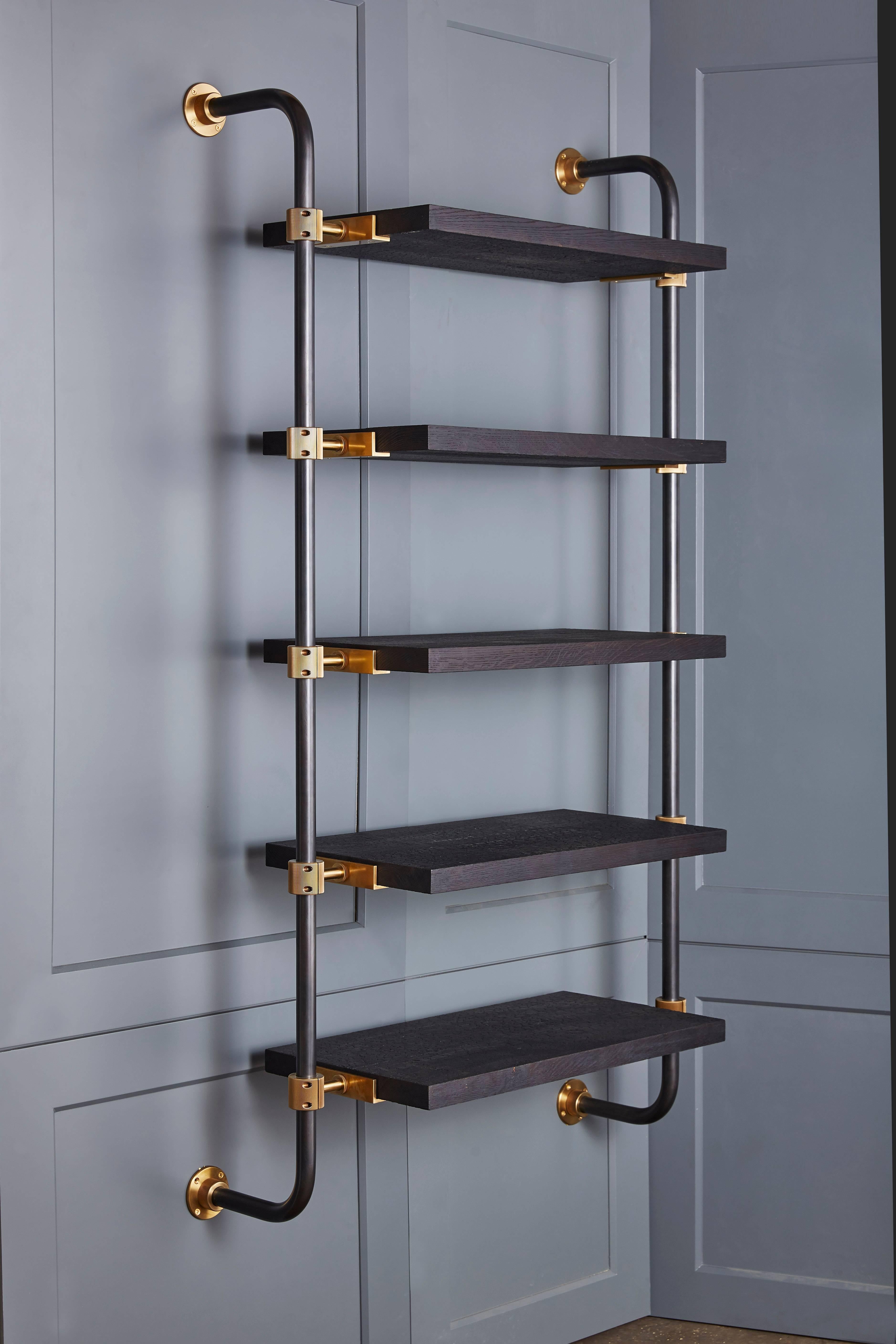 This single bay of our Loft Shelving is wall-mounted to support five shelves, using custom machined brass fittings on bent steel posts. Amuneal’s proprietary machined hardware clamps onto the posts so that the shelves can be easily adjusted at any