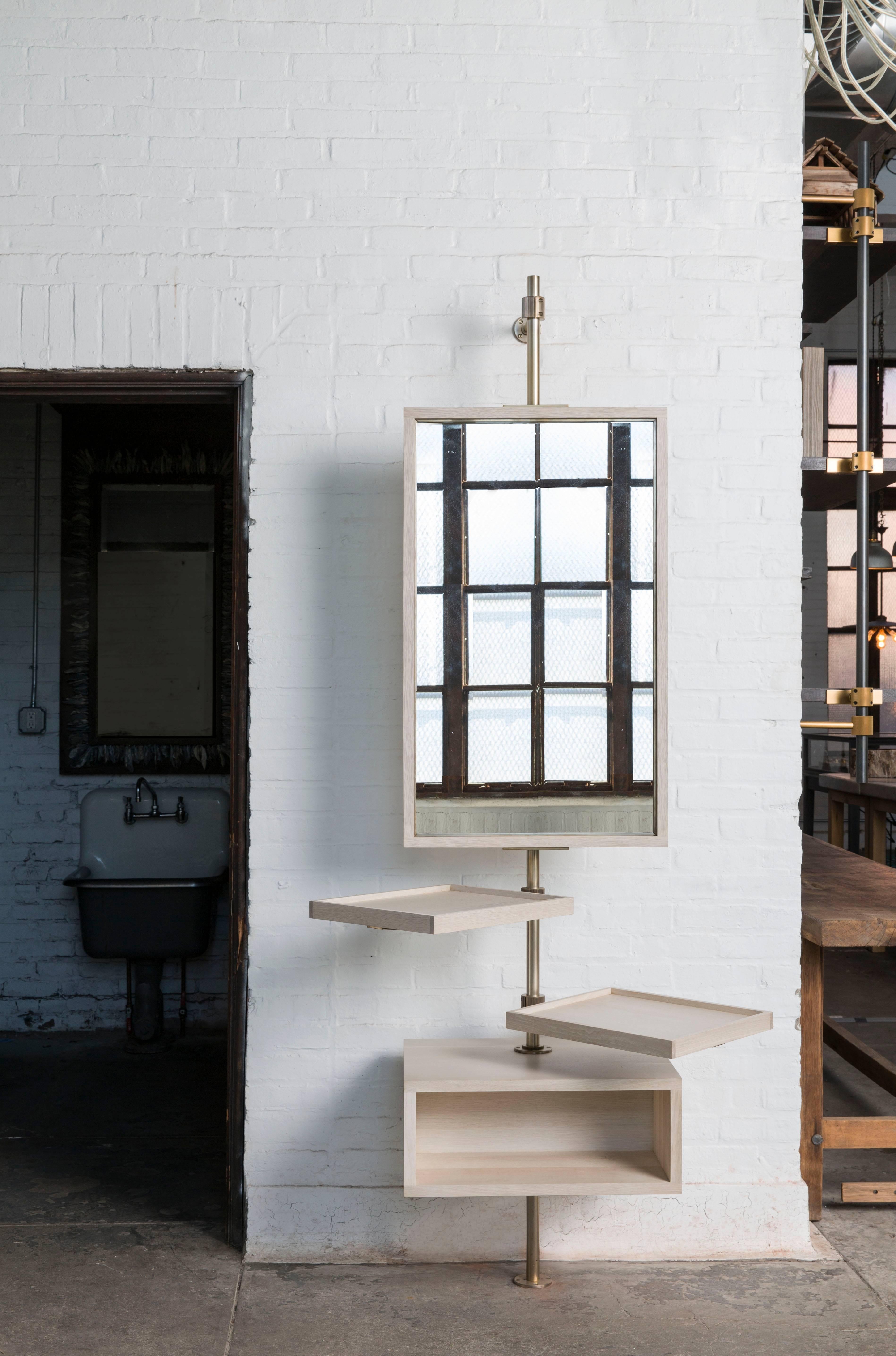 Amuneal’s loft system uses a series of custom fittings, machined from solid brass, that allow each component to be easily reconfigured around a single post. The metal components on this Single Post Loft unit with Mirror and Console are all