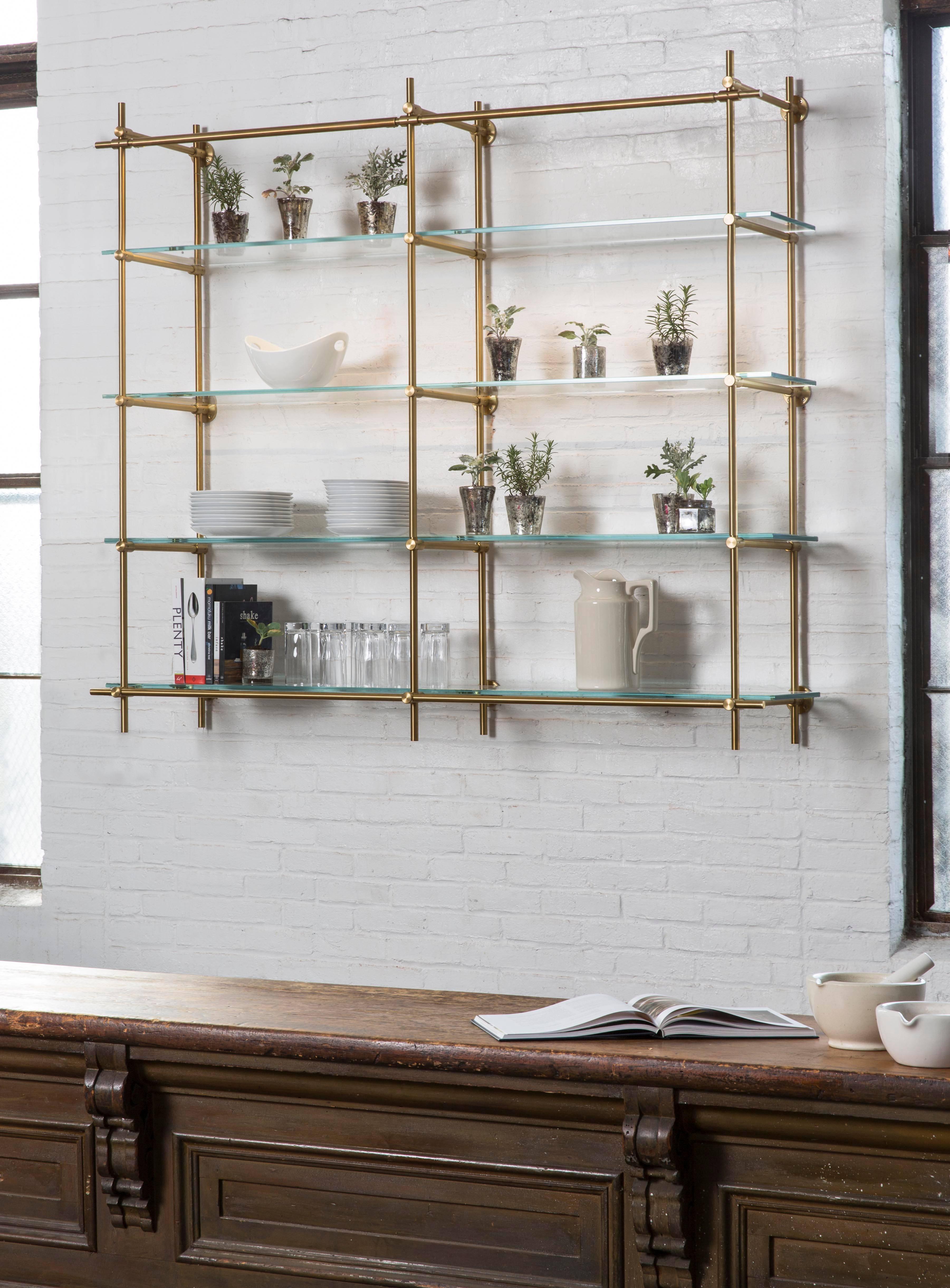 This two bay hanging shelving unit is part of Amuneal’s Collector’s Shelving System and features our precision machined brass fittings and tubes in a hand applied warm brass finish. The upper horizontal tube contains integral LED lighting to
