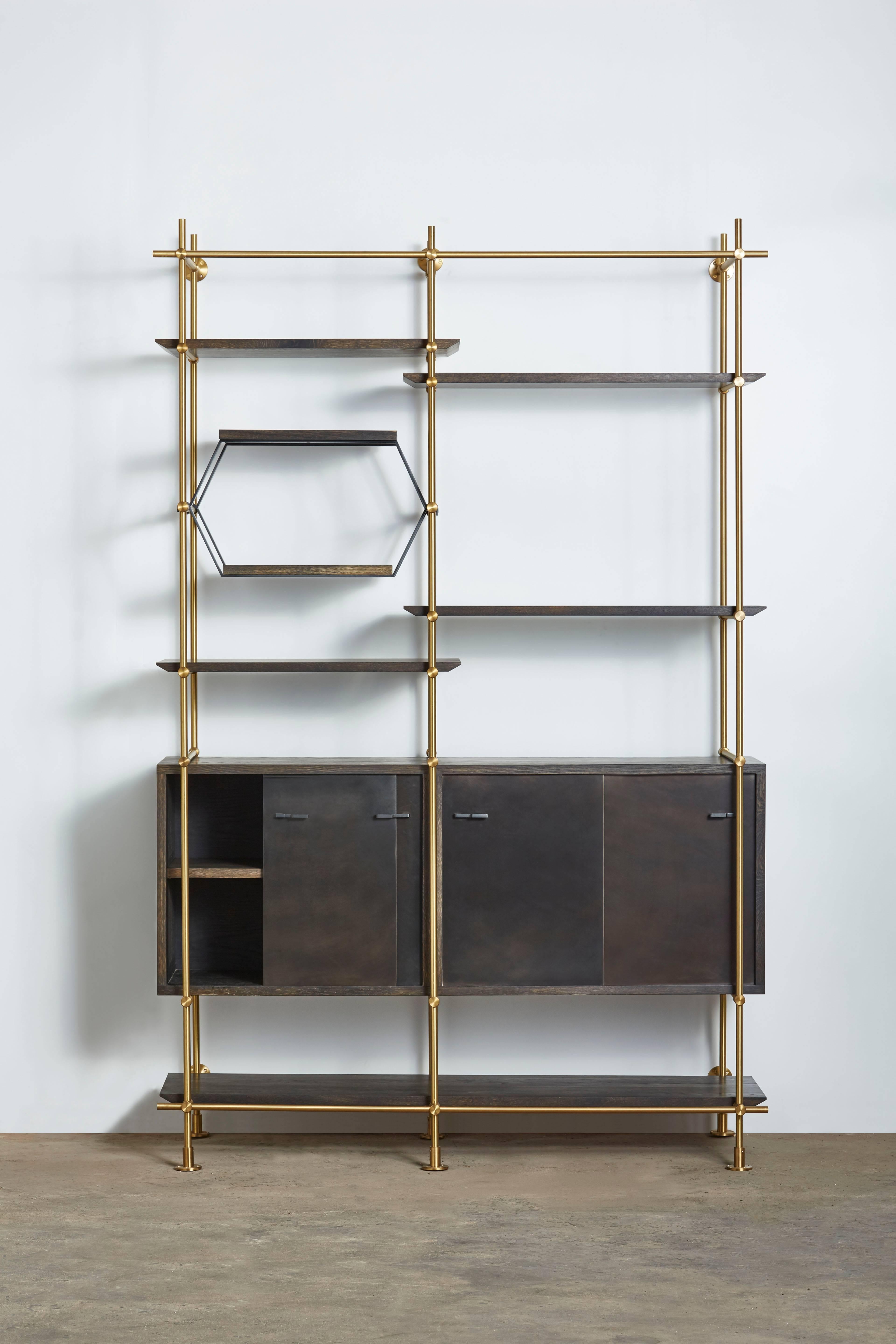 This two bay version of Amuneal’s collector’s shelving unit features solid machined brass fittings and posts in a warm brass finish. The unit mounts to the floor and to the wall to support a series of easily adjustable shelves and credenza cabinet