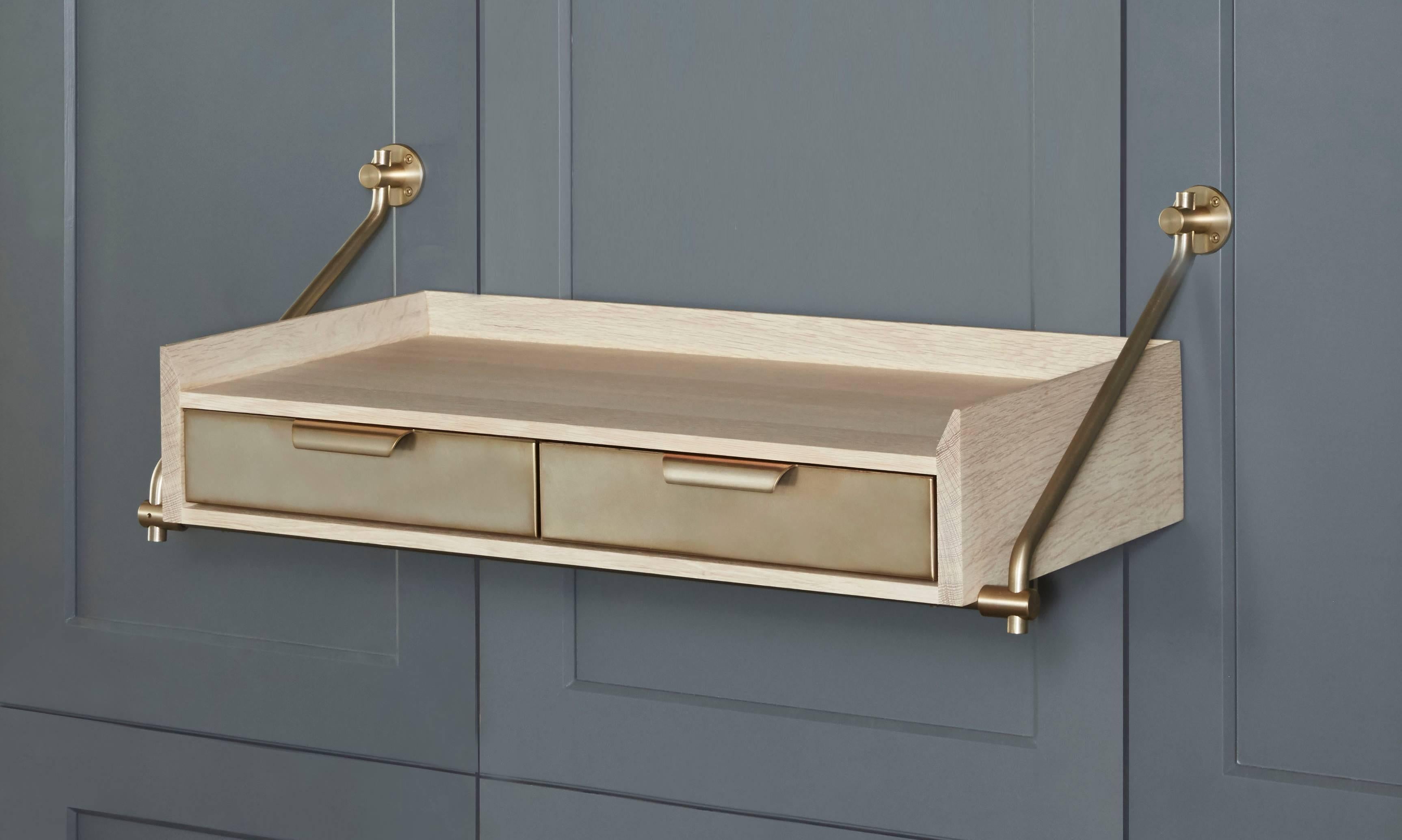 Amuneal’s wall hanging bleached oak console table uses our traditional Collector’s Shelving hardware to support this two-drawer unit with raised knife-edge surround. The scale of the unit and its unique floating design make it a great entry table,